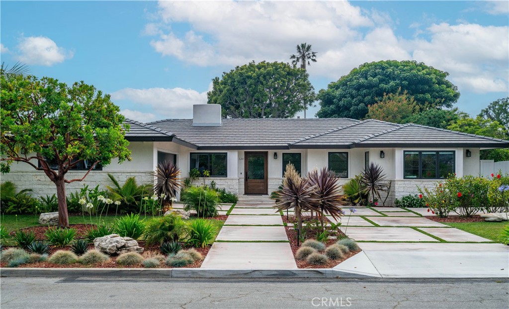 Just steps from the ocean and nestled in the exclusive Rocky Point Estates—home to some of Palos Verdes Estates’ most distinguished properties—this dramatic one-level residence offers an exceptional blend of privacy, sophistication, and relaxed coastal living. Originally constructed by a builder as his personal residence, the home reflects meticulous attention to detail and thoughtful craftsmanship throughout. Soaring ceilings and retractable walls of glass create a seamless indoor-outdoor experience, opening onto expansive patios and a sprawling lawn—generous enough to accommodate a pool—perfect for entertaining or enjoying quiet afternoons in the sun. Designed to capture the refreshing coastal breezes and the invigorating scent of ocean air, the home exudes the tranquility of a luxury retreat. The flowing floor plan connects formal living and dining spaces with a stunning chef’s kitchen, creating an ideal setting for gatherings both large and intimate. Beautiful hardwood floors run throughout, anchored by two wood-burning fireplaces that bring warmth and ambiance to the living and family rooms. Each of the four bedrooms includes its own ensuite bathroom, with the private primary suite offering a peaceful sanctuary. Additional features include a new roof, ceiling fans throughout, two tankless water heaters, and a charming greenhouse. Located in the heart of Palos Verdes Estates—one of Southern California’s most picturesque and prestigious coastal communities—residents enjoy lush landscaping, dramatic ocean bluffs, scenic hiking trails, and an unparalleled sense of peace and security. The city is renowned for its commitment to preserving natural beauty, its top-rated public schools (three of which are within walking distance of this home), and its close-knit, welcoming community. This ideal location offers convenient access off the hill while also granting residents the opportunity to join the city-owned Palos Verdes Beach and Athletic Club—an exclusive oceanfront facility featuring a pool, fitness center, and private beach access—as well as membership options at the Palos Verdes Golf Club and Tennis Club. From morning walks along the clifftops to dining at Lunada Bay Plaza, this home is a rare opportunity to fully embrace the refined, relaxed Southern California lifestyle.
