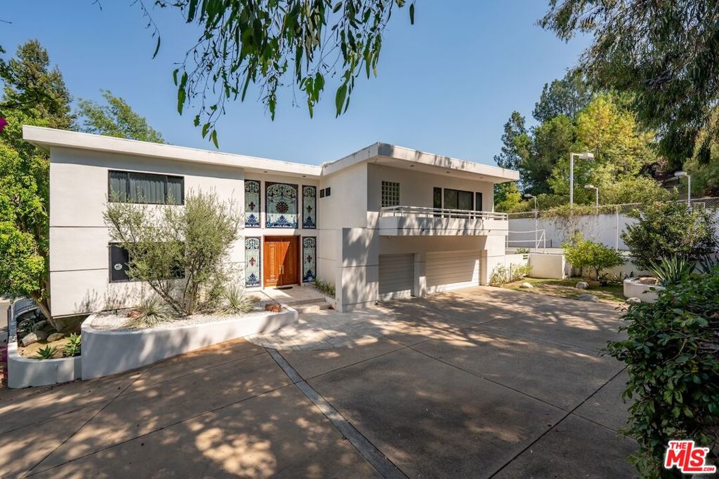 Private Gated Villa with Tennis Court in Royal WoodsTucked away on a quiet cul-de-sac in the coveted Royal Woods of Sherman Oaks, this gated villa offers the perfect blend of privacy, scale, and lifestyle. A true urban oasis and entertainer's dream, the nearly 20,000 sq ft lot features an elevated flat pad with unmatched seclusion, hillside views, and endless opportunities for gatherings. The grounds include a motor court, 3-car garage, sparkling pool, and private tennis court.Inside, approximately 5,000 sq ft of light-filled living space is defined by soaring ceilings, wide hallways, and expansive rooms. The open family room with wet bar flows seamlessly outdoors to the pool and tennis court, ideal for entertaining. Upstairs, the luxurious primary suite is joined by three spacious en suite bedrooms. On the main level, a den/office and fifth bedroom sit just off the entry, perfect for work-from-home or guests.With easy Westside access via Sepulveda or the 405, this high-impact estate combines convenience with complete serenity.