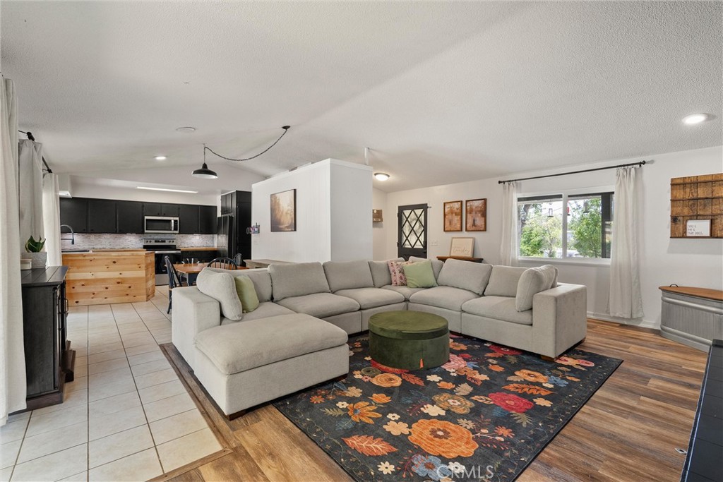Spacious & Stylish Oroville Home with Bonus Room & Owned Solar! Step inside this beautifully updated 2-bedroom, 2-bathroom home and be welcomed by a bright, open-concept layout that blends comfort and functionality. With over 2,170 square feet of living space on a generous 0.35-acre lot, this home has room for everyone—and everything. The living area features newer flooring, vaulted ceilings, a cozy gas fireplace, and large windows that fill the space with natural light. The adjacent kitchen is very inviting, complete with a newer appliances, perfect for casual meals or entertaining. Just off the main living area, you'll find a massive bonus room—ideal for a game room, family hangout, or even a third bedroom. With the exposed wood beam ceilings and a built-in bar, it’s an entertainer’s dream. Both bedrooms are generously sized, and the two full bathrooms offer plenty of space. A hallway laundry area with a stackable washer and dryer adds convenience. Outside, the covered porch is perfect for relaxing and enjoying your morning coffee. There’s also a large two-car garage with extra storage, a spacious driveway, and room to park an RV or recreational toys. With owned solar, updated windows, and two fireplaces, this home is both energy-efficient and cozy. Enjoy being just minutes from Lake Oroville and local landmarks like the Feather River and Downtown Oroville. Whether you're looking for comfort, space, or the perfect place to entertain—this property truly has it all. Come see it for yourself! Call your Realtor to set up a showing!