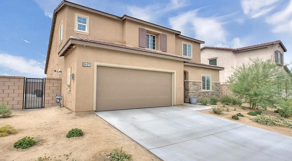 Welcome to this stunning 4-bedroom, 3-bath home offering 2,277 sq. ft. of stylish living in the desirable gated community of Monte Vina. Built in 2022, this residence combines contemporary design with thoughtful upgrades, making it perfect for both full-time living and desert getaways.Step inside to a bright, open floor plan with luxury vinyl plank flooring, soaring ceilings, and abundant natural light. The gourmet kitchen features quartz countertops, stainless steel appliances, a large center island, and a walk-in pantrya"ideal for everyday meals and entertaining alike.The home includes a convenient main-floor guest suite, spacious loft, and a primary retreat with a spa-style bathroom complete with dual vanities, a walk-in shower, and generous closet space. A built-in bar with floating shelves adds a touch of sophistication to the upstairs living area.Energy efficiency and smart living come built-in with owned solar panels and modern smart-home technology. The backyard is ready to be transformed with a plumbed drip system and professional landscaping plans included.Located just minutes from golf, shopping, dining, and festivals, this Monte Vina gem blends low-maintenance living with the comfort and style of a brand-new home.