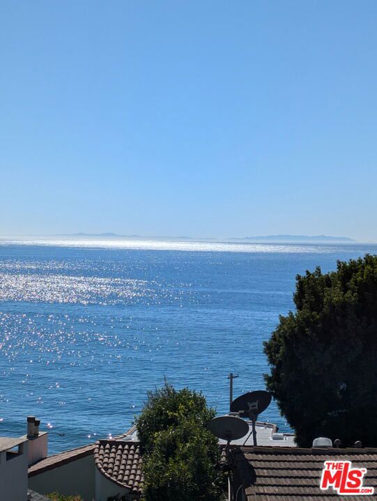 Panoramic ocean views, golden sunsets, and peaceful sea breezes. Perched on a quiet bluff above Castle Rock Beach, just minutes from the Getty Villa and Sunset Boulevard, this serene Pacific Palisades lot offers the perfect combination of views, tranquility, and proximity to the sand. A short stroll down Porto Marina leads to a pedestrian bridge with direct beach access, making daily seaside walks a future reality. Lovingly held by the same family for over 50 years, the original 2-bed, 2-bath home (1,318 sq ft per title) was lost in the Palisades Fire. In 2004-2005, an 800 sq ft addition was constructed. The sellers believed it to have been fully permitted, but LADBS does not appear to have records of any permits being finalized and all paperwork related to the construction was lost in the fire. While this may affect eligibility for a larger home under express rebuild provisions, buyers are encouraged to explore future development potential with the City. The property has been fully cleared (Phase 1 & 2) by the Army Corps of Engineers, leaving two flat pads: one at street level where the garage originally stood, and a larger upper pad, set behind a still-standing retaining wall, where the home was originally built in 1955. Whether you're looking to recreate a cherished legacy or design something entirely new, this rare lot offers a compelling opportunity in one of the Palisades' most peaceful, view-rich settings -- just moments from the sand.