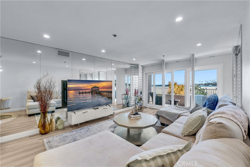 Beautifully updated 2 bedroom 2 bath ground floor end unit beachfront condo. This immaculate and serene home is filled with natural light and offers delightful ocean views from the living area and primary bedroom.. Beach access is just over the balcony. The remodeled kitchen features upgraded appliances including washer and dryer. The home has newer flooring and recessed lighting. Residents enjoy amenities including a rooftop deck, pool and jacuzzi, clubhouse, and sauna creating the perfect blend of relaxation and comfort in an impressive location.