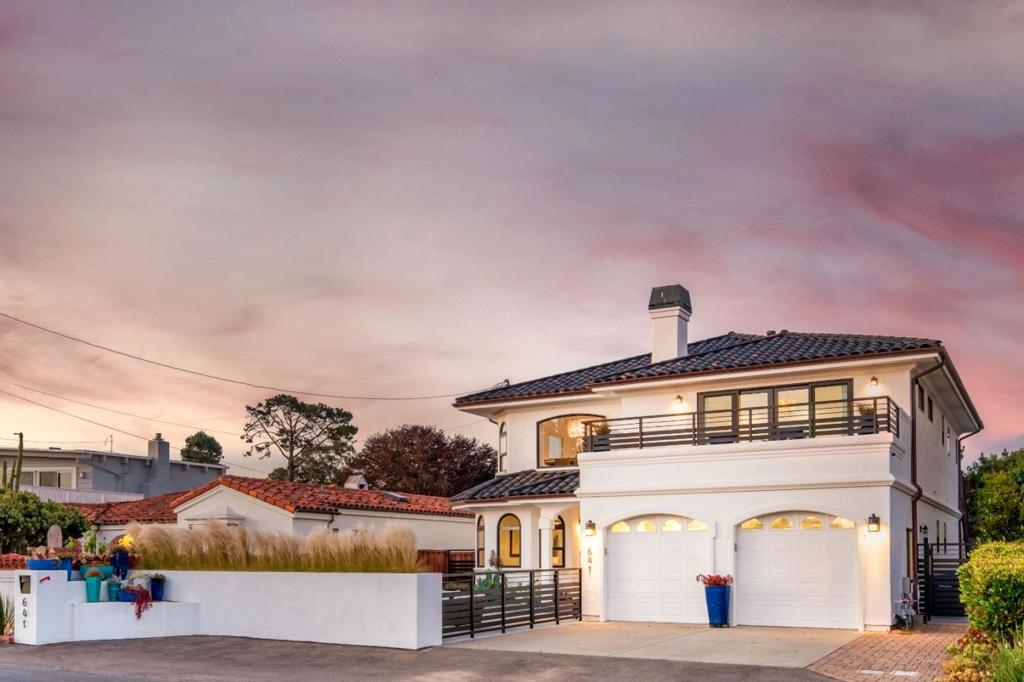 Buying an artists home means stepping into something you can't recreate, a place where ocean views, rare craftsmanship, and distinctive design come together in one of Aptos' most sought after locations. This home truly captures what luxury coastal living should feel like. Every detail has been curated to serve the ocean views. Sculptural light fixtures throughout, and custom tile work you won't find replicated anywhere else. Wolf and Café appliances, a steam oven, and custom cabinetry make the kitchen as practical as it is beautiful, the kind of space where friends gather around the island as you open the doors and the ocean air moves through perfectly. Two decks extend the living spaces outside. One is the spot for that first cup of coffee. The other is where evenings naturally drift, wine, conversation, and the view stretching ahead. The backyard stretches further than you'd expect for a coastal property. It's fully fenced and open, with room for long outdoor meals, pets to roam freely, and the simple luxury of walking barefoot through the grass as the day begins. Here, comfort and intention meet, and every choice feels undeniably connected to the ocean.
