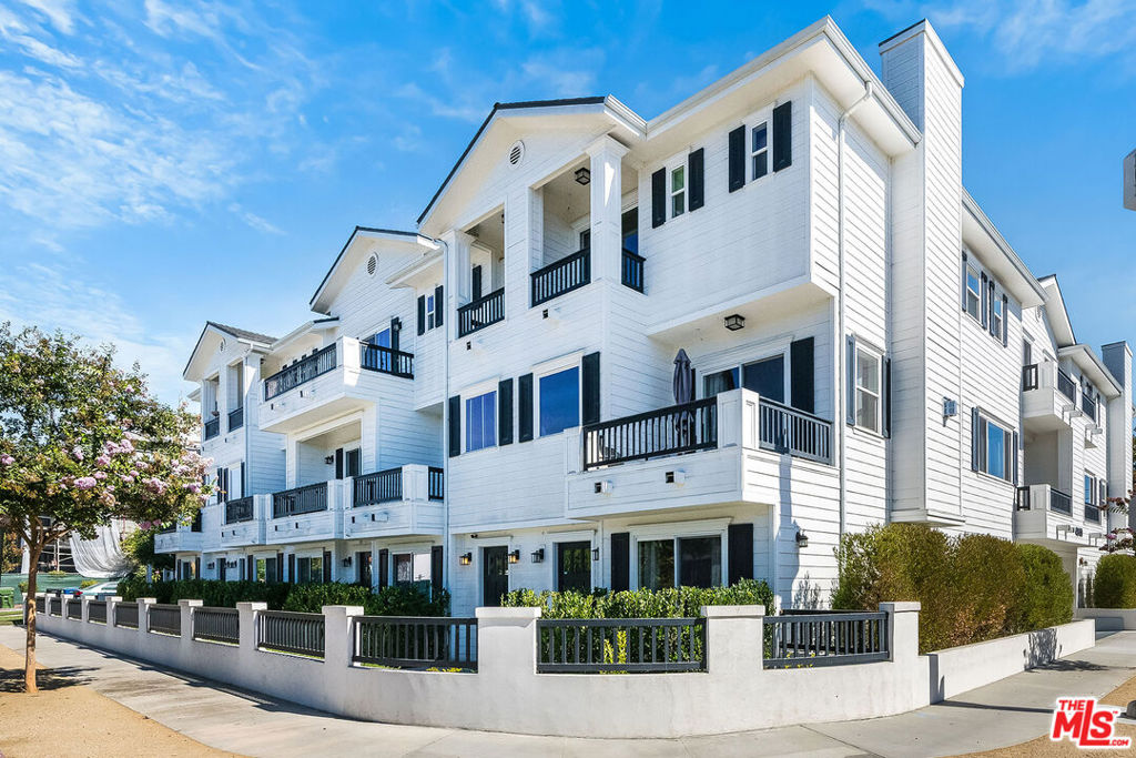 Stunning Hamptons style tri-level townhome in NoHo Arts District, Toluca Lake adjacent. Luxury living with first floor entry, guest quarters/office/fitness studio, full bath, lovely garden patio and stairs to main floor where you'll find an open plan showcasing the private terrace, entertainer's living room and dining room, dine-in kitchen featuring beautiful cabinetry, quartz countertops and stainless steel appliances incl. stackable laundry pair. Upstairs double doors lead to airy master with private balcony, great views, wish list walk-in closet and spa-like en suite for two complete with double quartz vanity and generous glass shower plus third and fourth guest bedrooms that share a hallway bath. High-end finishes and smart home technology throughout. Enjoy convenience of attached 2-car garage. Ranked very walkable neighborhood!