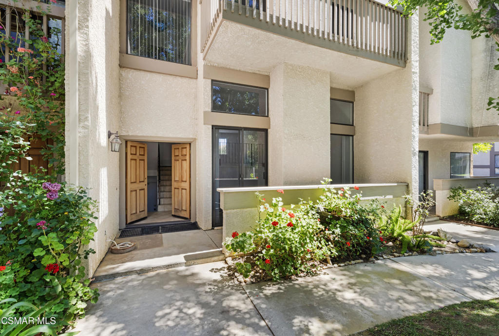 Welcome to Alizia Canyon Townhomes with the allure of the Malibu beaches only 15 minutes away! This townhome has one of the best locations in the development with serene views of the open area. Located in the back of the development affords a quiet and private location. Walk through the double door entry into the living area with spacious cathedral ceilings and a fireplace. and an open floor plan. Step up to a formal dining area and kitchen that has been updated with white hardwood cabinets, quartz counters and stainless appliances there are dark hardwood floors throughout the townhome. Upstairs is the Primary bedroom which has a in-suite bath. Large secondary bedroom, like another primary! First floor has a powder bath. Attached two car garage with the laundry. Wonderful amenities, pool, tennis and beautiful landscaped grounds. All of this and also you are in the Las Virgenes school district!