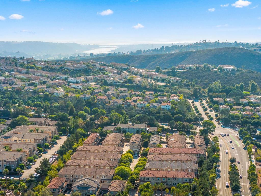 Amazing opportunity to own this light, bright, and airy turnkey 3BR/3BA corner-unit townhome in Solaire! You'll love the 9' ceilings, walls of windows, smart upgrades, and prime location between San Elijo Hills & La Costa. Come home and enjoy tranquil hillside & treetop views from most rooms. Inside, you'll find newly installed kitchen & bathroom cabinets, quartz countertops, low-maintenance modern tile flooring, and sleek LED lighting & fixture upgrades throughout. The kitchen features a stylish quartz waterfall edge, breakfast bar, and open layout to the living & dining areas. Appliances include a newly installed stainless steel microwave, dishwasher, and 5-burner smart range w/ Wi-Fi & voice control, packed w/ features sure to bring out your inner chef. The freshly painted interior, energy-efficient lighting, in-unit laundry, and attached 2-car garage add to the move-in-ready appeal. The top floor features both the primary suite and a secondary suite. The primary includes a spacious walk-in closet w/ a custom built-in organization system. All closets throughout the home are thoughtfully outfitted w/ built-in shelving. Additional highlights include wiring for built-in speakers, plus data & coaxial connections in the living room & all 3 bedrooms, ideal for modern living & work-from-home setups. Solaire offers a resort-style lifestyle w/ a sparkling pool, spa, fire pit, BBQ, and dining area overlooking scenic hills. You're just minutes from hiking & biking trails, La Costa Town Center, San Elijo shops & cafés, Cal State San Marcos, and top-rated schools. Convenient access to dining, grocery, fitness studios, and major retailers makes everyday living easy. Plus, you're less than 10 miles to South Ponto Beach & the Batiquitos Lagoon trail network, which offers beautiful walking paths and scenic nature experiences. This home blends thoughtful upgrades, functional design, and an incredible location. Opportunities like this don’t wait. Come see it today and make it yours before it’s gone! WOW ~ Welcome Home!