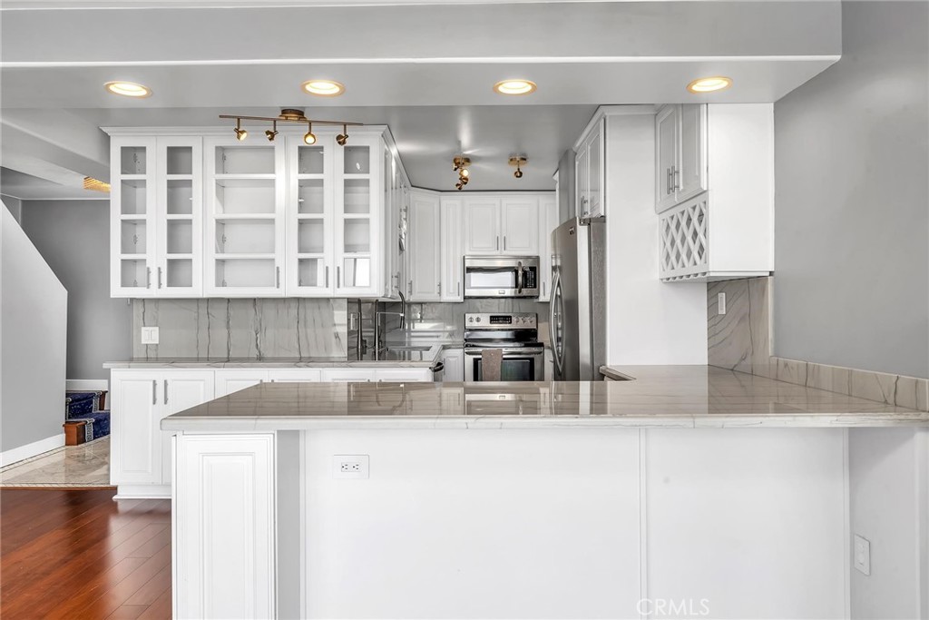 Gorgeous sunsets and refreshing coastal breezes can be enjoyed from this stunning ocean view condo. This North-west facing condo is beautifully appointed. Interior offers custom tile entry, modern lighting, electronic window treatments with optional blackout curtains, gorgeous electric fireplace, wood floors throughout and much more. The open-concept living space offers an expanded gourmet kitchen with the living and dining areas overlooking the beautiful Pacific ocean. This kitchen has an abundance of cabinetry, a wine fridge and stainless steel appliances. Views of the Pacific continue in the primary suite and also from the secondary bedroom. Primary bedroom has spacious walk-in closet, and a lovely updated bathroom. Ocean view outdoor spaces include a generous front patio ideal for entertaining or dining al fresco with family and friends, as well as a spacious balconies from the bedrooms where you can relax and fully appreciate the ocean and sunset views. Tandem car garage provides plenty of space for your vehicle and storage. The well-maintained Ocean Plaza complex features outdoor spa, huge swimming pool, ocean view deck, clubhouse and gym. HOA paid by owner includes internet, basic cable, water and waste disposal. This location is a short walk to Redondo Pier, best beaches of Redondo, Hermosa, Manhattan, and the Riviera village with an array of shops and restaurants.