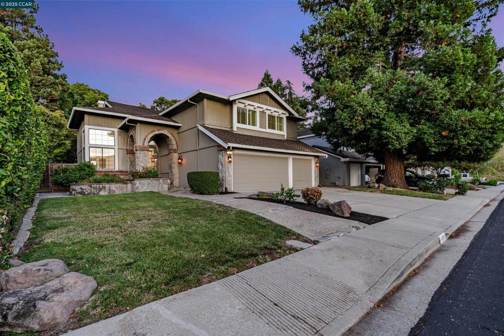 Welcome to this spectacular residence in the heart of Danville’s Wood Ranch neighborhood, where comfort and convenience meet in a spacious setting. Offering 5 bedrooms, 3 full bathrooms, and 2,900 square feet of living space on a 6,500 square foot lot, the home is just moments from the community pool and clubhouse. Inside, soaring ceilings and walls of windows create a bright and airy atmosphere in the formal living and dining rooms. The kitchen is designed for both cooking and gathering, showcasing granite counters, white cabinetry, a large island, and a casual breakfast nook that opens to the family room and backyard. The first floor also includes a versatile bedroom, a beautifully remodeled bathroom with walk in shower, and a convenient laundry room with access to a 3 car garage. Upstairs, a private primary suite serves as a retreat with a sitting area, dual sided fireplace, generous walk in closet, and a spa like bath with soaking tub and separate shower. Three additional bedrooms and another full bath complete the second level. Outdoors, low maintenance landscaping with turf, a patio, and a relaxing spa provide a wonderful space for entertaining or unwinding. This is a home that combines modern updates with everyday livability in one of Danville’s most desirable communities.