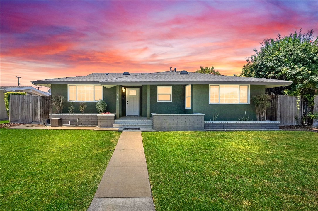 Beautifully remodeled and ideally located just minutes from Disneyland, this stunning home blends modern upgrades with timeless charm. The updated kitchen features custom wood cabinetry, granite countertops, stainless steel appliances, recessed lighting, and a spacious island with seating—perfect for entertaining. The adjoining dining area offers ample space for large family gatherings or memorable celebrations. All bathrooms have been tastefully upgraded with custom tile finishes and walk-in showers, creating a luxurious, spa-like atmosphere. Throughout the home, you'll find new engineered hardwood flooring, baseboards, fresh interior and exterior paint, and smooth scraped ceilings that enhance the modern aesthetic. Additional improvements include newer dual-pane windows for energy efficiency, updated electrical and copper plumbing, central A/C, and a tankless water heater. The inviting backyard is designed for both relaxation and entertainment, featuring a covered patio, a dedicated gathering space, and potential for RV or extra parking. This move-in-ready home offers comfort, style, and unbeatable convenience—all just a short drive from the Happiest Place on Earth.