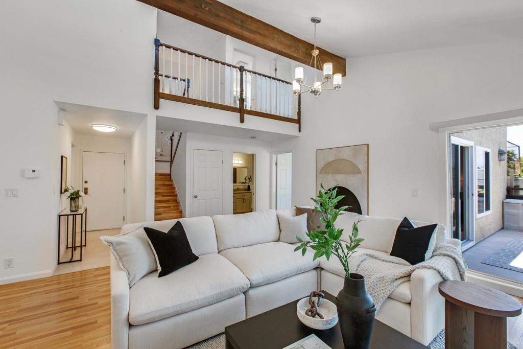 This impressive two-story, 2 bedroom and 2 bath condo offers approximately 1,608 sq. ft. of beautifully designed living space in a boutique building with a small HOA, fostering an intimate, community-focused environment. Enjoy the peace of mind of a two-story design, ensuring extra privacy and peaceful comfort. The expansive open-concept layout is ideal for relaxing and entertaining, featuring generous living and dining areas with vaulted ceilings and large windows that fill the space with natural light. The thoughtfully updated kitchen offers ample cabinetry and counter space. Both bathrooms have been tastefully updated, and each bedroom includes a large walk-in closet. The spacious upstairs primary suite features a private bathroom with skylight, while the second bedroom and full bathroom offer flexibility for guests or a home office. Additional highlights include in-unit laundry, extra storage, and two assigned parking spaces in the secure garage. Enjoy the convenience of being just moments away from the vibrant 25th Avenue shopping district, with its inviting cafes, diverse restaurants, and local boutiques. With its generous size and prime location, this San Mateo condo offers an exceptional opportunity to create the ideal place to call home.
