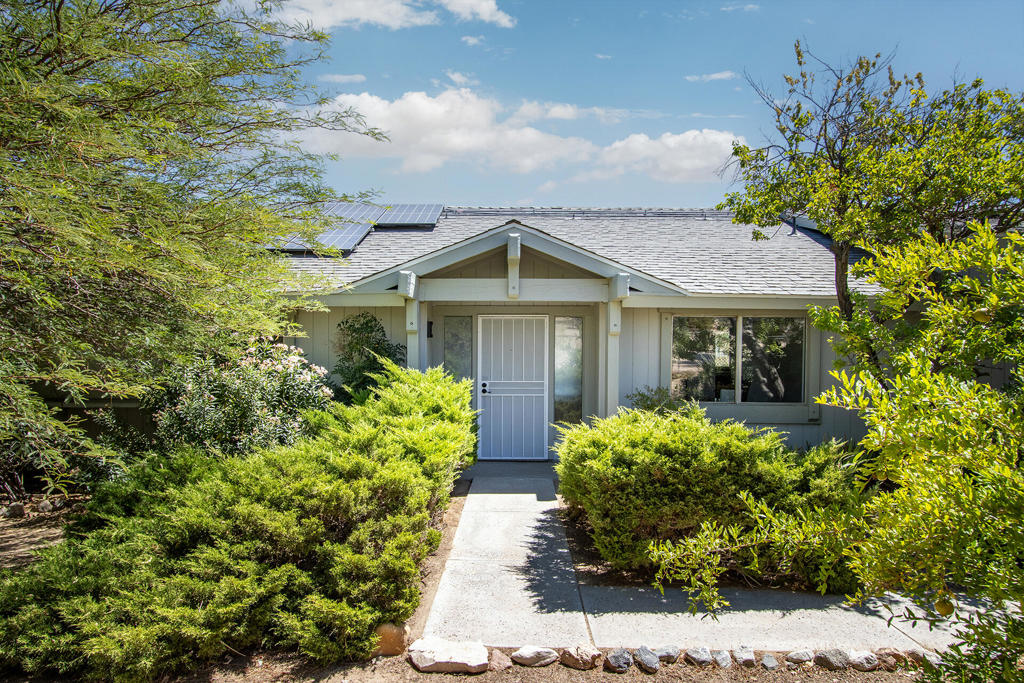 Wonderful family home set on over 2 acres in prestigious Rancho Mesa Estates. Surpassing over 2,100 square feet this large home features 3 bedrooms, 2 bathrooms, vaulted entry, living, dining and family rooms, with an additional large bonus room with woodburning stove. The large laundry room has ample storage and counterspace. Glass doors from the living room and family room open to covered patios providing sweeping sunrise to sunset views. The entire property is fenced and gated with an electronic keypad and remote control access. As you enter the gate the oversized 2.5 car garage provides easy access, ample storage, built-in cabinetry, a half bathroom, and a dedicated workshop with a woodburning stove, skylights and more tranquil views. Next to the garage is a covered RV parking area. The property also features mature trees and landscaping and a lovely covered gazebo. Property has been well maintained and includes a solar system for energy efficient year round enjoyment. Perfect location within minutes to all the amenities, restaurants, and recreational opportunities in Joshua Tree, Pioneertown, and Yucca Valley. This would be a perfect full-time residence, investment, and rental. Don't wait on this one - schedule your showing today.