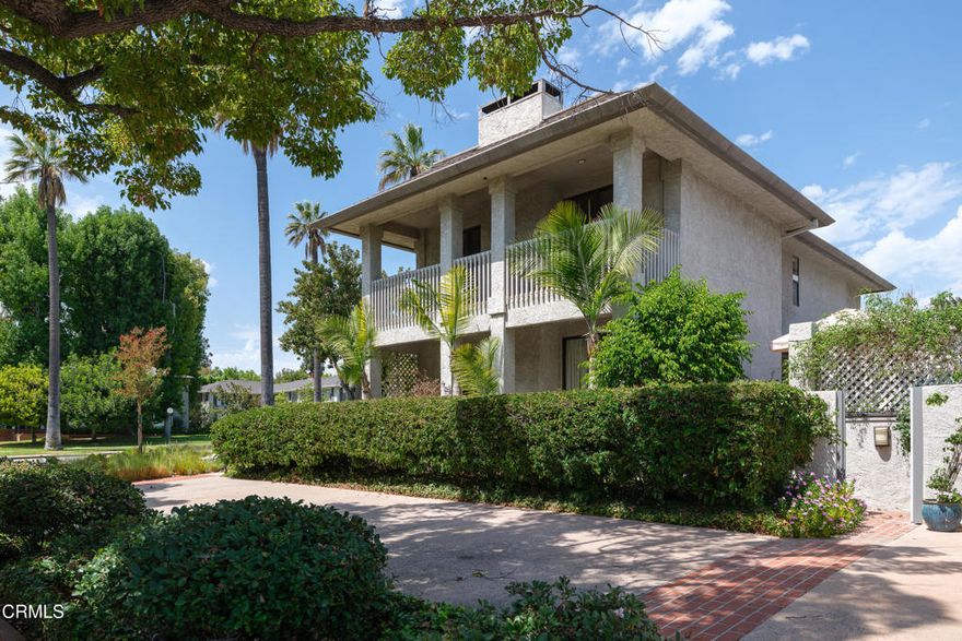 A rare luxury find nestled on the corner of Orange Grove and Madeline Drive, this freestanding residence offers the privacy and feel of a single-family home with the convenience of luxury condominium living. With no shared walls, timeless architecture, and expansive indoor-outdoor spaces, this one-of-a-kind property is an entertainer's dream in one of Pasadena's most sought-after locations. Lush and vibrant landscaping leads you to the front door, where, beyond the grand front entry, hardwood floors lead into elegant living and dining rooms adorned with crown and chair rail moldings. A gas fireplace with a stone hearth and classic white mantle creates a warm focal point in the living room, where dual glass sliders open to a private side patio. A built-in wet bar adds ease for entertaining, while the dining room seamlessly connects to the patio. The gourmet kitchen impresses with stone counters, a custom backsplash, a farmhouse sink, a 5-burner Samsung range, dishwasher, and breakfast nook with sliding doors that open to the back patio oasis. The flexible floor plan includes a downstairs bedroom (currently used as an office/den space) and an adjacent stylish 3/4 bath. Upstairs, two well-sized bedrooms share access to a generous balcony, while a beautifully updated bathroom features a custom-tiled shower and dual vanity. The spacious primary suite offers a walk-in closet and a spa-inspired ensuite with dual sinks, stone counters, and an oversized shower with bench seating. The crown jewel is the expansive 1,700+ sq ft private back patio, complete with stone tile, pergola-covered lounge areas, a fountain centerpiece, and ample room for al fresco dining or sun-soaked relaxation. Additional highlights include indoor laundry, secured subterranean parking and abundant closet and storage spaces, including a private locked storage room. Perfectly situated along Pasadena's famed South Orange Grove corridor, this residence not only delivers refined living but also front-row access to the iconic Rose Parade. A truly rare opportunity to own a stand-alone luxury home in one of Pasadena's most prestigious settings.