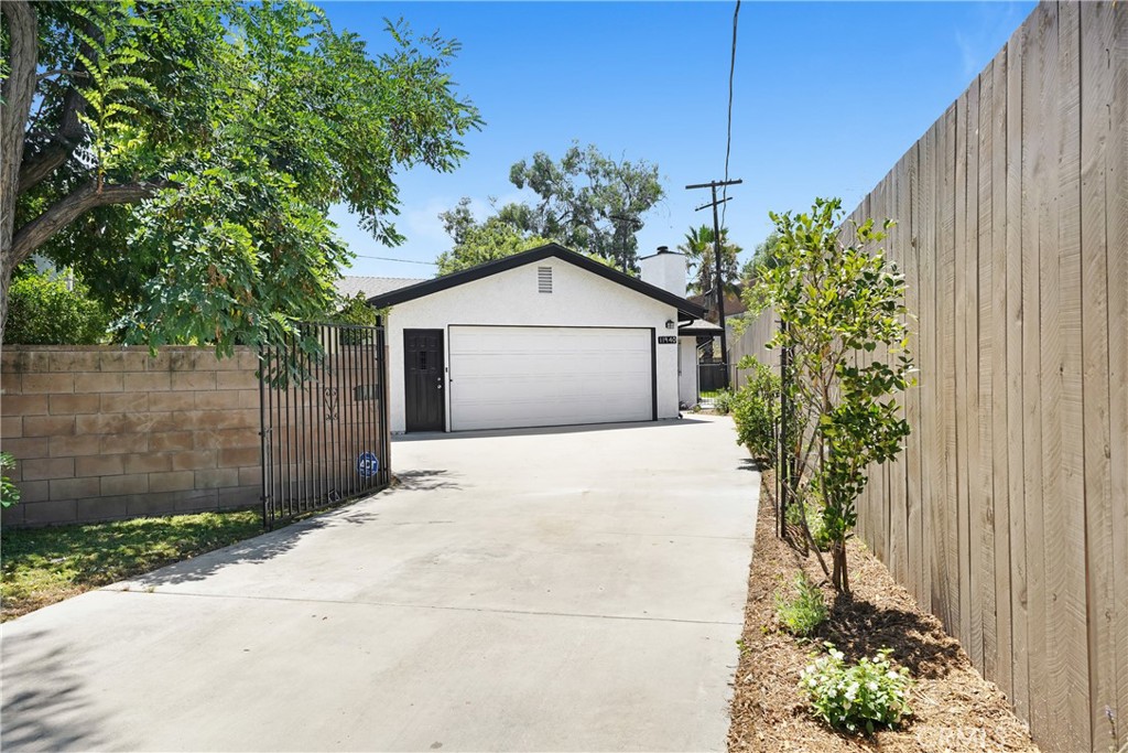 Stunning Remodeled Valley Village Home for Lease – Privacy, Style, and Space! Welcome to this beautifully remodeled inside & out, new landscaping, 2-bedroom, 2-bathroom home located in the highly coveted Laurel Grove enclave of Valley Village. Nestled at the end of a quiet tree-lined street, this gated property offers rare privacy and safety with 8-foot fencing surrounding the home. Enjoy the peace of a neighborhood with only one way in and one way out — homes here are seldom available for rent or sale. Step inside to soaring vaulted ceilings, recessed lighting, vinyl plank wood flooring, a wood-burning fireplace, keyless entry, huge picture windows, a sliding door, new window woodlook coverings, and an expansive open-concept floor plan that seamlessly connects the living, dining, and kitchen areas. The updated chef's kitchen features stainless steel appliances, ample cabinetry, a wine storage rack, a breakfast bar, and a spacious layout perfect for entertaining. Both bedrooms are generously sized, offering ample natural light and space to unwind. The primary esuite includes two massive closets. Outdoors, you’ll find a lush grassy yard and new landscaping, a large patio ideal for gatherings, and the ultimate in privacy. Washer and dryer hook-ups in an extra-large two-car attached garage, and thoughtful finishes inside and out. Located near NoHo West, shopping, dining, and with convenient access to major freeways, this home is truly a hidden gem. The gardening, pest, and HVAC 2x a year service is included.