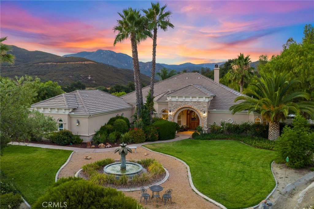 La Cresta Luxury Estate — Elegance, Acreage & Timeless Living Experience elevated living on 5.57 private acres in Murrieta’s prestigious La Cresta community. This 3,106 sq ft single-level estate offers 3 spacious bedrooms and 3 baths, masterfully designed with towering 9-foot ceilings, cathedral accents, and luminous designer windows that bathe the interiors in natural light. A chef’s kitchen steals the spotlight with granite slab countertops, custom cabinetry, an expansive dining island with sink, and open access to the entertainment-friendly living spaces.
Host with style in the formal dining room, unwind in the serene breakfast nook, or relax by the grand stone fireplace. The owner’s suite is a retreat of its own — featuring dual walk-in closets, direct patio access, and a spa-inspired bath with oversized soaking tub and dual-head shower. Secondary bedrooms are bright and generously sized, sharing a luxe full bath with impressive soaking tub, tiled walk-in shower and dual craftsmanship sinks.
Step outside to your manicured paradise: an 8-ft-deep pool with strung lights, covered patio and additional pergola, lush landscaping, gated entry, panoramic views, and stereo outdoor speakers that set the mood for sunset gatherings. Fruit trees and your own private raised garden beds to created those delicious dishes. Horse lovers will appreciate direct access to scenic riding trails, with gently rolling terrain, and plenty of space for barns, paddocks, or arenas, your horses will thrive in harmony with the land. The expansive acreage and fenced perimeter provide freedom and safety, while panoramic views make every ride unforgettable. Estate includes a paid solar system, 1,000+ sq ft. 3-car garage with storage room, newer generator, reverse osmosis, and onsite well. RV Parking.
This is more than a home — it’s a lifestyle.
