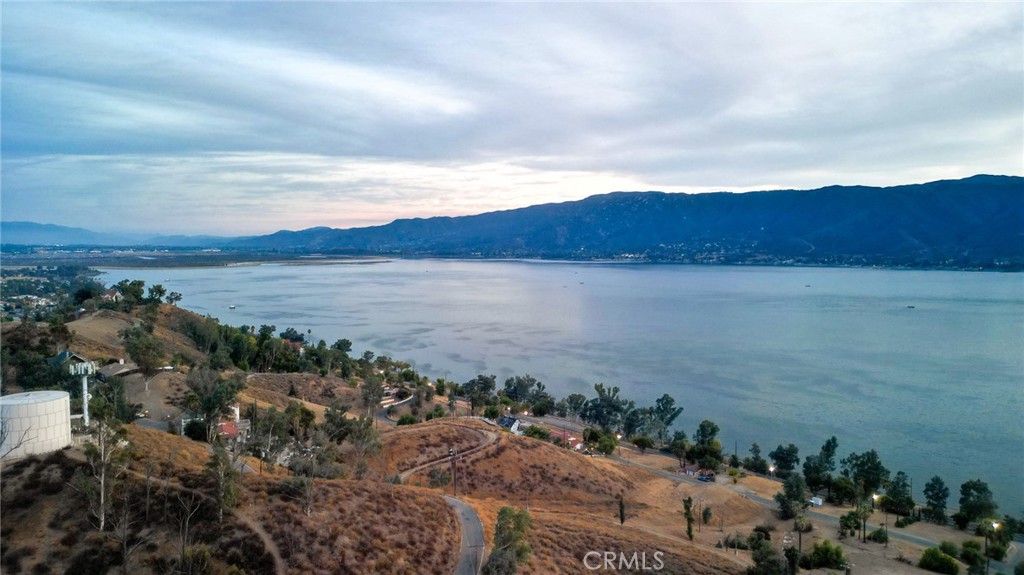 Set above the city in the scenic hills of Lake Elsinore, this 3,485 sq ft parcel offers a rare opportunity for land banking, recreational use, or future potential in one of Riverside County’s fastest-growing areas. The lot enjoys access to utilities at the lot line (buyer to verify), and its sloped terrain adds privacy and natural charm. Perfect for investors seeking affordable footholds in developing areas or outdoor enthusiasts looking for a personal hillside retreat just minutes from Lake Elsinore’s boating, trails, and outdoor attractions. Parcel No. 375-221-013. GPS: 33.681515, -117.352282.