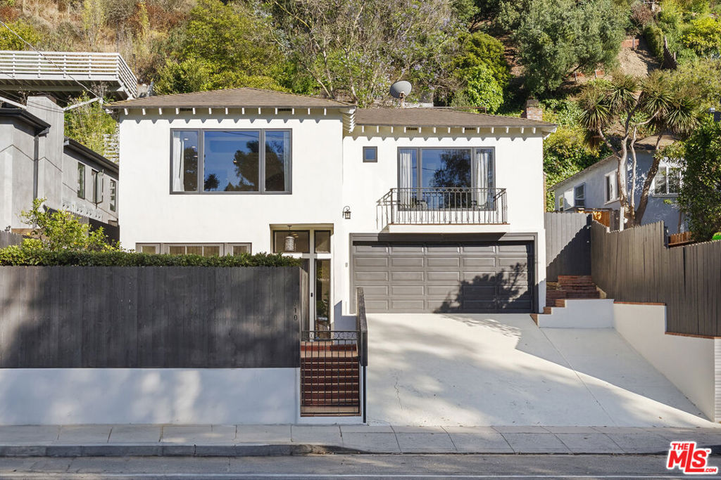 Nestled in the coveted Santa Monica Canyon, 410 Entrada Dr offers a serene private retreat moments from sandy beaches, hiking trails, and world-class dining. This light-filled home combines character and modern comforts, featuring vaulted ceilings, exposed beams, hardwood floors, and custom Spanish tile details. The main level includes a spacious living room with French doors leading to a lush front patio, a remodeled kitchen with high-end appliances, and an elegant primary suite with a fireplace, walk-in closet, and spa-inspired bath. Two additional bedrooms, one opening to the terraced backyard, provide flexible living options. The outdoor spaces include a private garden with dining and lounging areas, a hot tub, and a tranquil canyon view. Additional features include air conditioning, a secure two-car garage, and ample driveway parking. This is a rare opportunity to own a home in one of Los Angeles' most sought-after neighborhoods.