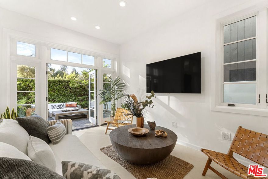 Nestled in the coveted Santa Monica Canyon, 410 Entrada Dr offers a serene private retreat moments from sandy beaches, hiking trails, and world-class dining. This light-filled home combines character and modern comforts, featuring vaulted ceilings, exposed beams, hardwood floors, and custom Spanish tile details. The main level includes a spacious living room with French doors leading to a lush front patio, a remodeled kitchen with high-end appliances, and an elegant primary suite with a fireplace, walk-in closet, and spa-inspired bath. Two additional bedrooms, one opening to the terraced backyard, provide flexible living options. The outdoor spaces include a private garden with dining and lounging areas, a hot tub, and a tranquil canyon view. Additional features include air conditioning, a secure two-car garage, and ample driveway parking. This is a rare opportunity to own a home in one of Los Angeles' most sought-after neighborhoods.