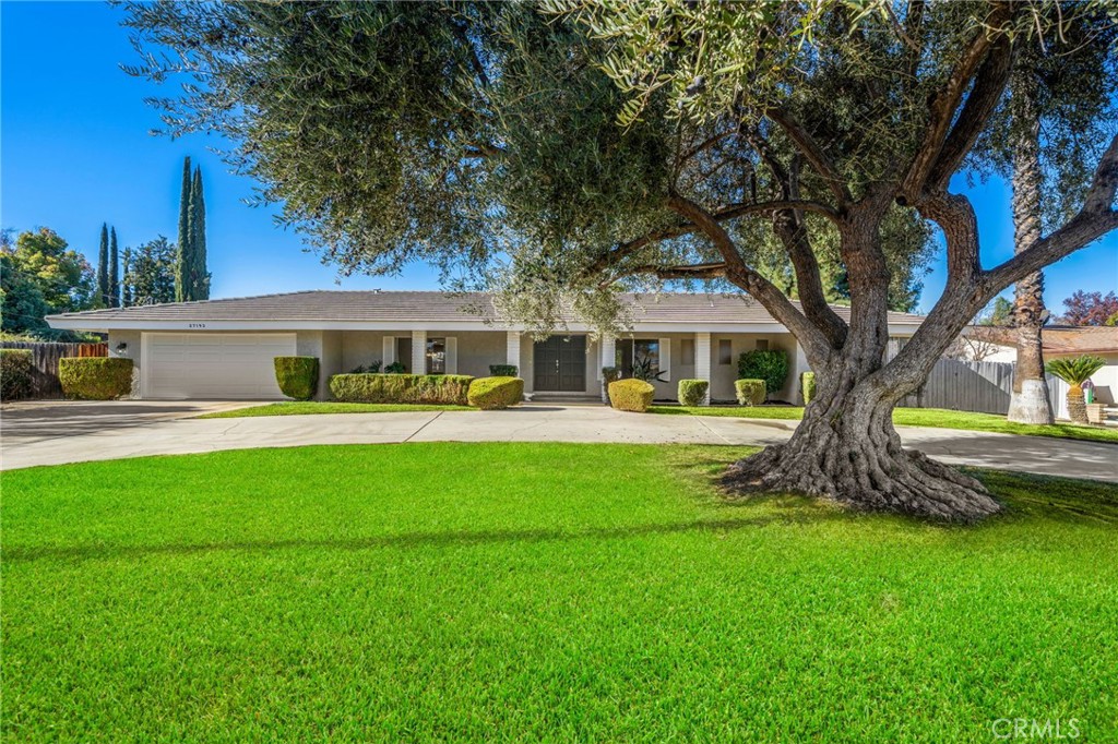 GORGEOUS REMODELED SINGLE STORY 3 BEDROOM POOL HOME ON OVER A THIRD OF AN ACRE LOT!!! SO MANY UPGRADES AND UPDATES INCLUDING THE PRIMARY SUITE HAS BEEN THOUGHTFULLY ENHANCED WITH A WALL ADDITION CREATING A DEFINED SEPARATION BETWEEN THE BEDROOM AND BATHROOM FOR ADDED PRIVACY, NEW mini mud room, NEW HVAC system, NEW appliances, NEW water heater, NEW pool equipment, NEW interior and exterior paint, NEW luxury vinyl plank flooring, NEW lighting inside and out, Whole house fan and so many more updates you need to see to believe. This gorgeously remodeled 2200+ sq ft pool home nestled in a sought-after Hemet neighborhood!!! This beautiful single story 3 bed 2.5 bath home offers 2,247 sq ft of upgraded living space on a 16,553 sq ft lot. Immediately greeted by the grand entrance, the home is bright and inviting with elegant refinement and new flooring and carpet throughout. The spacious living room is perfect for entertaining or relaxing and features a two-sided fireplace opposite another living area. The offset kitchen boasts new appliances, plenty of storage, countertop seating, new lighting, easy access to the formal dining room, and a gorgeous view of the backyard. Retreat to the primary suite with plenty of closet space, ceiling fan, corner windows, and an en-suite bathroom. All bedrooms are bright and spacious with easy access to the upgraded bathrooms. Step outside to your backyard oasis boasting plenty of room for outdoor entertaining, low maintenance landscaping, multiple eating areas, fruit trees, and a gated sparkling pool with new pool equipment and new water within the last 4 months. This home is the perfect balance of elegance and relaxation. Located near schools, highways, and shopping. You don’t want to miss out on this amazing home!