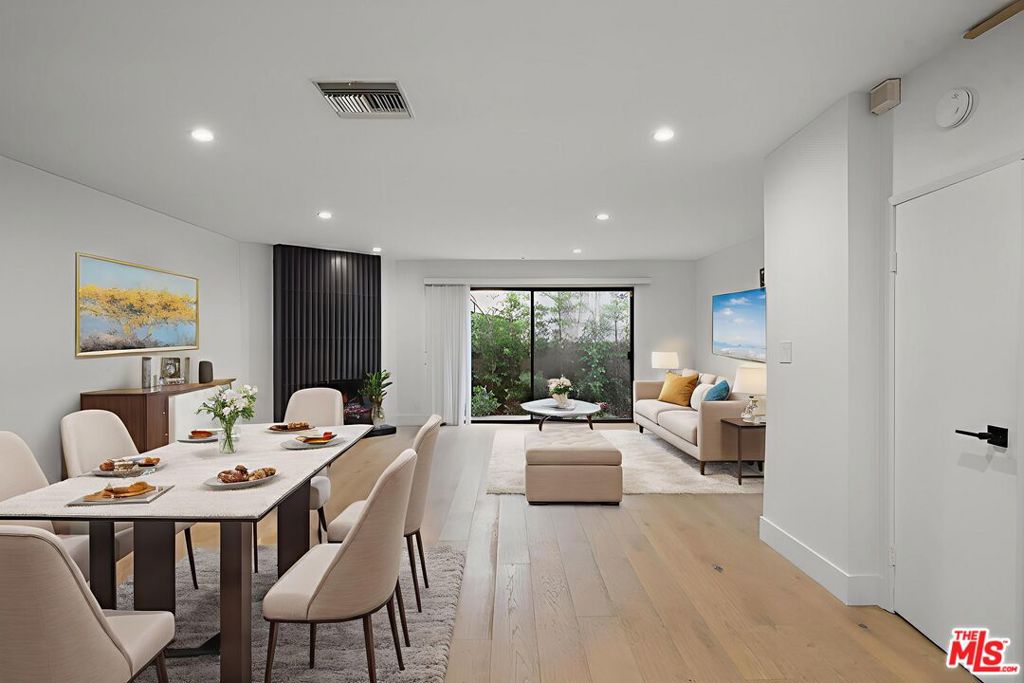 Nestled on a quiet, tree-lined street in the heart of Santa Monica, this beautifully reimagined 2-bedroom, 2.5-bath townhouse blends modern sophistication with timeless coastal charm. Located in an intimate 6-unit building with secure gated, side-by-side parking, this turnkey residence offers effortless living just minutes from the beach. The main level welcomes you with an open-concept layout that seamlessly connects the living and dining areas to a stylish, contemporary kitchen featuring stainless steel appliances, designer tile backsplash, and warm, daylight-inspired lighting. A chic powder room adds functionality and flair, perfect for guests and everyday living. Upstairs, two spacious bedrooms each feature their own thoughtfully designed ensuite bathrooms, while a skylight above the hallway bathes the upper floor in natural light, creating an airy, sun-kissed ambiance. The unit also features a spacious patio with newly landscaped ficus to give you maximum privacy. The convenience of in-unit laundry completes this thoughtfully updated home. With nothing left to do but move in and start enjoying the Santa Monica lifestyle, 1807 10th Street is a rare opportunity to own a low-maintenance, design-forward home in one of L.A.'s most coveted coastal communities. Whether it's morning coffee at Layla Bagels, sunset sips at Bodega Wine Bar, or weekend rides along the oceanfront, your perfect Westside retreat awaits.