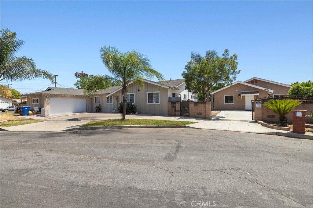 This spacious corner-lot property in Panorama City features two separate units, each with its own private entrance and address. The main home offers 4 bedrooms, 3 bathrooms, and approximately 2,040 square feet of living space. It includes a bright, open living room with a fireplace, a large kitchen with ample cabinet space, and a 2-car attached garage with a generous driveway. The ADU, built in 2019, offers a separate entrance, 2 bedrooms, 2 bathrooms, 1,091 square feet of living space, spacious living room with recessed lighting, and a modern kitchen with stainless steel appliances. The bedrooms are generously sized, featuring ceiling fans and mirrored closet doors. Sitting on a 12,844 square foot lot, this property is centrally located near shopping, dining, and other amenities.