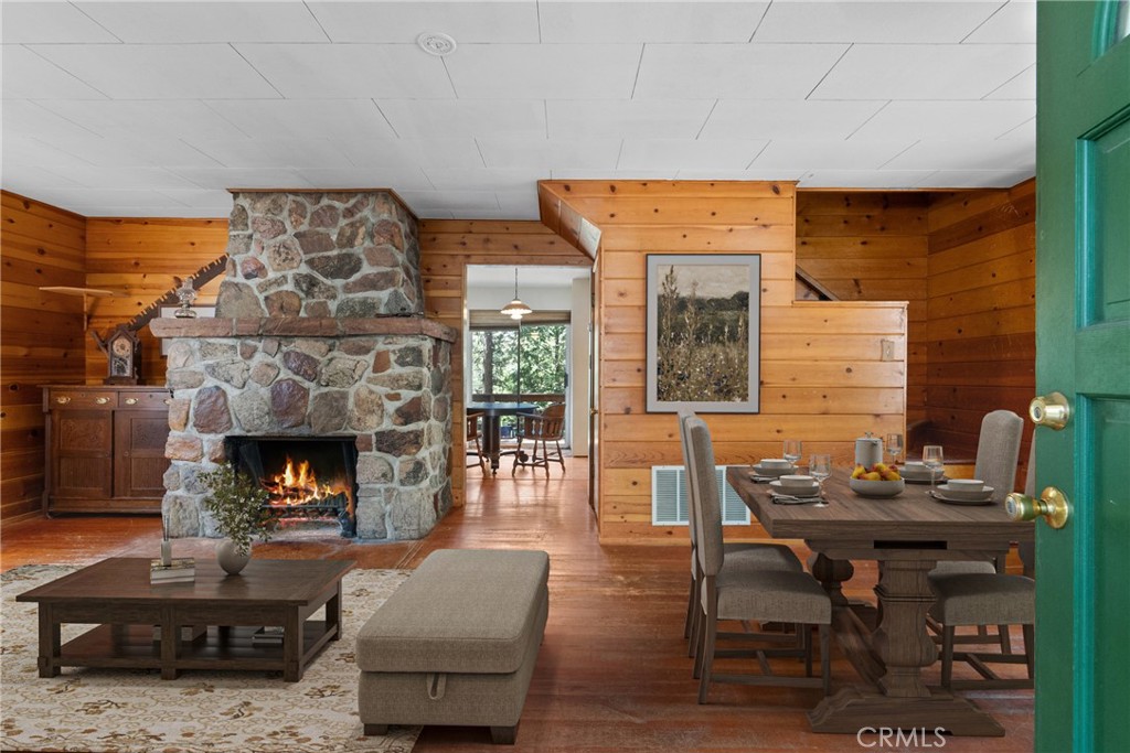 Welcome to 26251 Alpine Lane, a cozy and character-rich cabin nestled in the heart of Twin Peaks. Less than 10 minutes from the lakefront in Lake Arrowhead Village, this mountain retreat offers the perfect blend of rustic charm and modern comfort. Step onto the expansive wrap-around deck and soak in breathtaking mountain views — ideal for morning coffee or evening gatherings. The large circular driveway provides easy access and ample parking for guests. Inside, the warm and inviting living space is anchored by a stunning custom oversized brick fireplace — a true centerpiece for cozy nights in. The cabin-style interiors add a timeless mountain feel, while thoughtful updates make this home move-in ready. The finished side yard features an additional deck, creating a perfect space for outdoor entertaining or quiet relaxation. Downstairs, a finished basement of approximately 300 sq ft includes a laundry area with washer and dryer, adding convenience and bonus living space. Whether you're looking for a peaceful full-time residence, a weekend getaway, or a vacation rental investment, this charming Alpine Lane property is a rare find in a sought-after location.