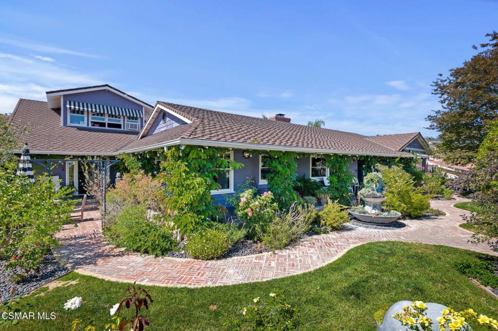 Truly One-of-a-Kind in Camarillo Heights. Welcome to this distinctive and architecturally compelling Craftsman-style home nestled on a 10,015 sq ft corner lot in the highly desirable Camarillo Heights neighborhood. With 4 bedrooms and 3.5 bathrooms--including a private upstairs guest suite--this 3,059 sq ft property blends timeless character with modern sophistication. Renovated and expanded in 2000 and lovingly updated and restored again in 2021.From the moment you arrive, this gated corner lot impresses with standout curb appeal. A grand stone staircase leads past a grove of giant birds of paradise and a dozen mature fruit trees through a custom arbor gate draped in a flowering passionfruit vine. The front yard is a serene, fully fenced private garden oasis with tropical foliage, a mature shade tree, custom Opiary NYC concrete planter feature and natural boulder formation seating along a winding brick path.The chef's kitchen is a true centerpiece--an inspired blend of country warmth and designer detail. It features a Bertazzoni 36'' induction range, Bertazzoni speed oven and dishwasher, Fisher & Paykel refrigerator, an oversized island with quartz counters, custom deep blue cabinets and roman blinds, a walk-in pantry with an artist-made door, reclaimed-style brick paver flooring, a corner eat-in kitchen storage bench, and Venetian Murano glass lighting by Siru.The original living and dining rooms have been reimagined into a dramatic formal dining and creative space but easily adaptable to a traditional layout if desired. Floor-to-ceiling windows with custom velvet drapes and rich flooring anchor the room with style and sophistication.The sunken living room is an architectural showpiece--an expansive space designed for both vibrant entertaining and relaxed lounging. Custom herringbone pattern dark solid oak floor. French doors framed by hand-laid brick tiles open directly onto the lush patio, inviting seamless indoor-outdoor living. Tiered landings add depth, while the open layout connects easily to the kitchen and outdoor areas - and a surprising little jewel of a half bath.The spacious primary suite offers a charming bohemian blend of romance and indoor-outdoor living. Step into a serene haven with vaulted ceilings, and a sense of calm anchored by the soft palette and layered textures. A wall of French doors opens wide to the back garden--perfect for slow mornings, afternoon reading, or starry night unwinding. There is ample closet space including a walk-in.Two additional spacious bedrooms with a full bathroom conveniently situated between them as well a a guest bathroom off the living room. Upstairs, a large private bonus suite offers flexible living with its own full bathroom and clawfoot tub, custom solid oak floor, vaulted ceilings, inspiring views, hardwired high-speed Internet and abundant natural light. Perfect as a guest quarters, studio, movie room or office.Step into a backyard sanctuary where every detail has been thoughtfully layered to create a sense of peace and privacy. Brick, stone, wood, lush greenery, and artisan ironwork blend seamlessly to form a rich, textural landscape. A custom water feature creates a tranquil soundtrack for daily living. French doors from nearly every corner of the home blur the line between indoors and out. A vine-covered gazebo high in a quiet corner provides the perfect setting for al fresco dining and bird's eye view of your entire domain. This garden retreat offers the kind of calm that's increasingly rare.Additional highlights include a two-car garage with a storage room, two tankless water heaters, newer furnace, whole-house water treatment, and Control4 smart home automation system. The home was previously featured on the Meadowlark Home Tour and the Camarillo Garden Tour.