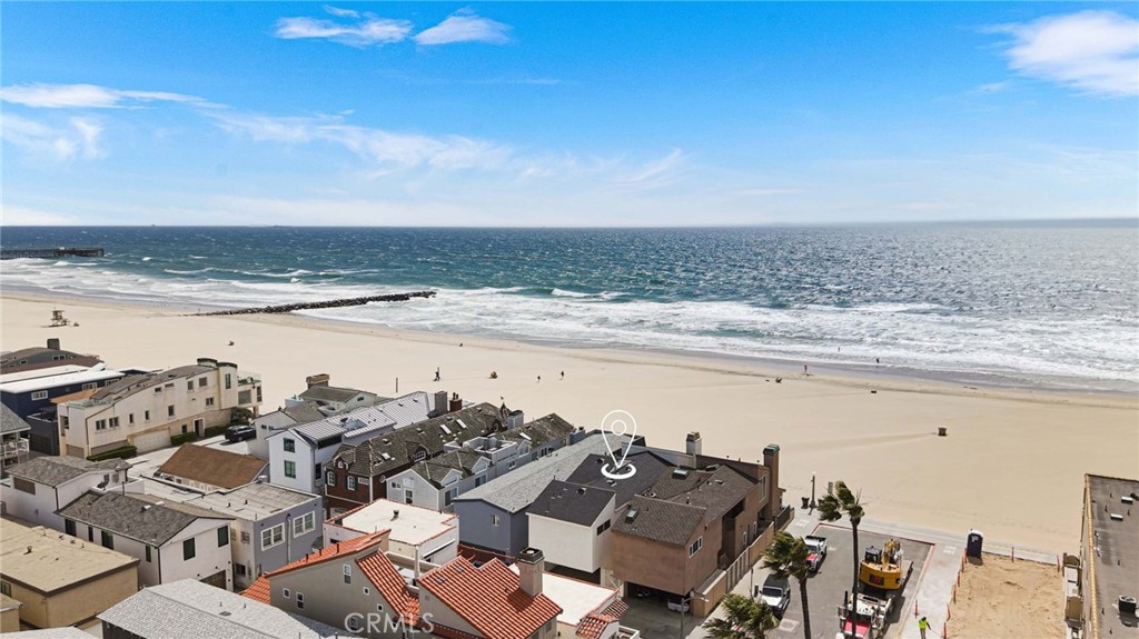 Live in one and rent the other? Lease them both for outstanding income potential? Or transform them into a large private compound? The choice is yours at this front-row oceanfront duplex in Newport Beach. Unobstructed views sweep across the Pacific Ocean and embrace the Newport Pier, romantic sunsets over Catalina Island, and evening lights along the coast as far north as Palos Verdes. Remodeled and upgraded, the duplex presents a total of four bedrooms and three baths in approximately 1,924 square feet and includes an outdoor after-beach shower, two carport spaces and one enclosed garage space. Featuring one bedroom and one bath, the first-level residence is fresh and modern, with a host of desirable appointments, and seamless living areas opening to a large beach-front patio. An updated fireplace surrounded by fashionable tile lends style to the living and dining rooms, while the recently reimagined kitchen shines with quartz countertops, white Shaker cabinetry with glass uppers, a full tile backsplash, and stainless steel appliances. The primary suite features a private ocean-view atrium and a chic ensuite bath with quartz countertop and a sliding glass door to the shower. Three bedrooms, including one with a third-level loft, await in the upper unit, which showcases two luxurious baths, vaulted ceilings, travertine floors, and a large resurfaced ocean-view deck with glass railing. A peninsula bar opens to the dining room from a kitchen with custom wood cabinets and stainless appliances, and the living room displays a handsome fireplace. Custom built-in wardrobes in the primary suite and one secondary bedroom are detailed with translucent glass doors and contemporary wood drawers. Both units offer the advantages of upgraded dual-pane windows and sliding glass doors. Located at the top of the Balboa Peninsula, this turnkey duplex is enviably set near the Balboa Fun Zone, Balboa Island, Fashion Island’s high-end shops and restaurants, Lido Marina Village, beach-front bike paths, and the neighboring communities of Corona del Mar, Newport Coast and Crystal Cove.