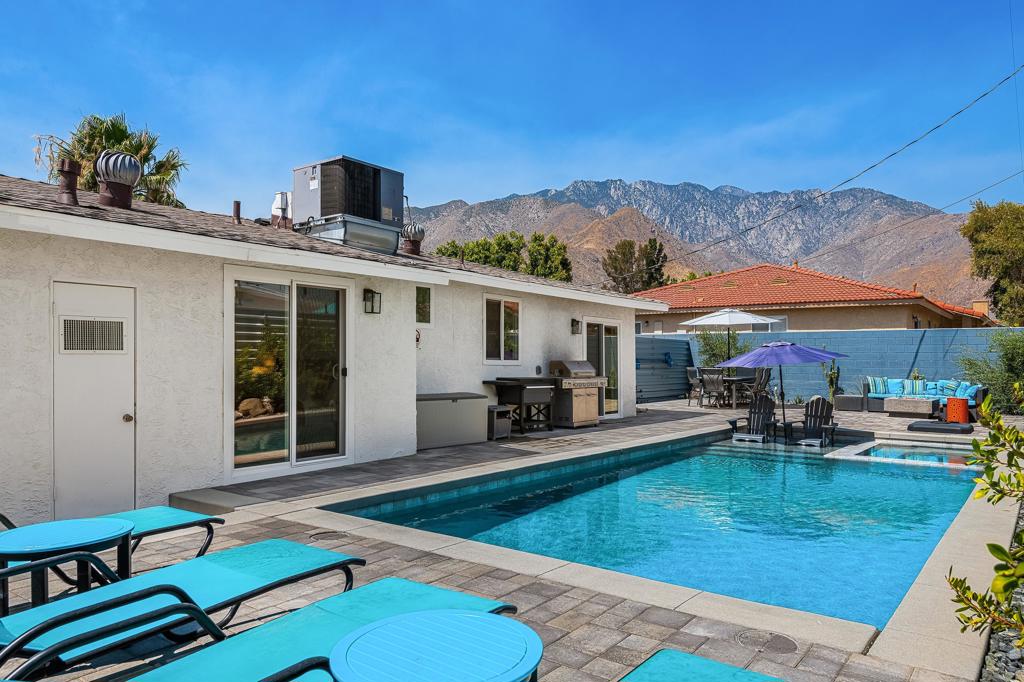 Stunning 3 bed / 2 bath modern masterpiece on a serene street in the historic Racquet Club community. This piece of Palm Springs perfection is newly renovated and completely reimagined. Upgrades include the Pebble Tech saltwater pool/spa, beautiful outdoor lighting, drought tolerant landscaping, upgraded irrigation system, bocce ball court, fire-pit, barbecue area, aluminum fencing, dual paned windows, engineered flooring, new kitchen cabinets/appliances with bright caesarstone quartz countertops, Ring cameras, and more. The expansive side yard can accommodate extra parking for an RV or boat. A NEMA 1450 car charging 240/50 amp receptacle is installed and ready to go. Nearly the entire home can be controlled remotely allowing for stress-free ownership. Ideally situated just minutes to all Palm Springs has to offer including downtown shopping, restaurants, casinos, and more. This successful short term rental has future bookings already in place and most importantly is within a neighborhood well under the 20% cap. You own the land and with no HOA there's everything to love about 356 Cortez.