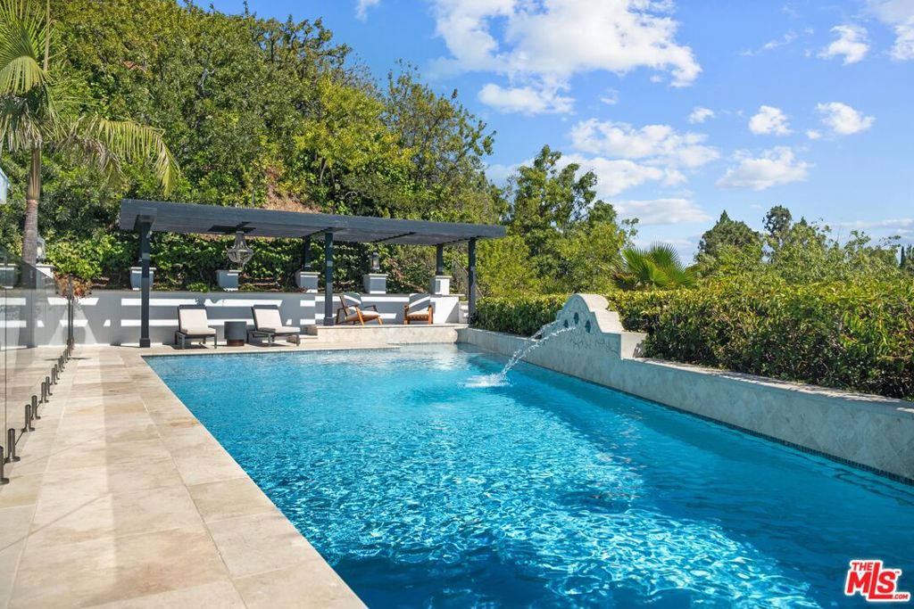 Just completed to perfection, this fully reimagined and fully furnished single-level Mid-Century Modern on a quiet Beverly Hills cul-de-sac offers an unrivaled blend of architectural elegance and contemporary luxury, with walls of glass framing sweeping canyon and glittering city-light views. Bathed in natural light, the open-concept interiors feature wide-plank hardwood floors, bespoke designer finishes, and a state-of-the-art chef's kitchen with custom cabinetry, waterfall stone counters, and professional-grade appliances. Outfitted with all brand-new high-end furniture, the home is move-in ready for the most discerning tenant. The resort-style backyard is a private oasis with a newly resurfaced gated pool, spa, outdoor shower, and multiple lounging and dining areas. The serene primary suite boasts direct pool access, a custom walk-in closet, and a spa-inspired bath with a freestanding soaking tub and glass-enclosed rain shower. Available furnished or unfurnished, with flexible lease terms and long-term lease options. Please contact us for availability and pricing! Please note that owner accept Cryptocurrencies a form of payment.