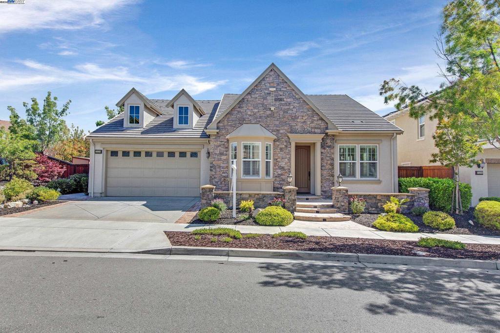 Welcome to this beautifully maintained single-story home in the highly sought-after Alamo Creek neighborhood of Danville. Featuring an open floorplan with elegant arched doorways, crown molding, and engineered hardwood flooring, this home blends charm with functionality. Enjoy formal living and dining rooms, plus a spacious kitchen-family room combo with bonus space perfect for a home office or additional dining area. The kitchen offers abundant cabinetry, a large center island, and stainless steel appliances. The family room is anchored by a cozy fireplace, ideal for relaxing or entertaining. The expansive primary suite is filled with natural light and features direct backyard access, a soaking tub, stall shower, and dual sinks. The spacious backyard includes mature landscaping and a side yard with space for gardening—perfect for outdoor living and enjoyment.