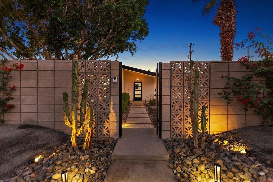 Newly remodeled and thoughtfully designed, this stunning home offers exceptional indoor-outdoor living with custom upgrades throughout. The backyard is an entertainer's dream featuring a 20' x 20' covered patio with two large ceiling fans, an additional 400 sq. ft. of outdoor living space, and views of the sparkling saltwater pool and spa. The outdoor kitchen is fully equipped with a cooktop, sink, built-in BBQ, and beverage chiller, perfect for year-round enjoyment. The property offers extra-long RV/boat pull-through parking, plus space for four additional vehicles in addition to the two-car garage. The front exterior is beautifully appointed with a block wall, flowering vines, and two automatic gates providing privacy, security, and convenience. Inside, the open-concept design showcases floor-to-ceiling sliders, a custom stone fireplace, and a chef's kitchen with high-end appliances, a wine fridge, and a butler's pantry. The luxurious primary suite features dual showers, marble finishes, and a freestanding soaking tub. The guest bathroom includes a steam shower and Bluetooth lighting for added comfort and relaxation. This home is equipped with numerous upgrades and thoughtful details throughout, a must-see to appreciate the quality and craftsmanship.