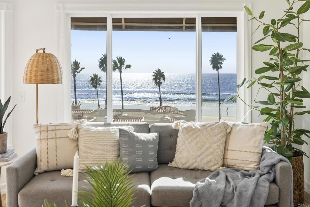 Jaw-dropping, show-stopping, sit-down whitewater, 180-degree ocean views are the centerpiece of this incredibly located Oceanside property. Perfectly situated between Pacific Street and The Strand in the beachfront community of San Miguel II, this single-level coastal retreat is elevated for privacy while capturing panoramic views stretching from La Jolla to Dana Point. The bright, open floor plan frames endless coastal vistas, with a west-facing great room that spills out onto the balcony—your front-row seat to the surf, pier, and sunsets. The kitchen is beautifully appointed with custom granite countertops, stainless-steel appliances, and a gas range, opening seamlessly to the living and dining areas. In the living room, enjoy ocean views in one direction and a cozy fireplace in the other—perfect for relaxing evenings. Wood-look tile floors throughout are as beautiful as they are practical, ideal for sandy toes or sandy paws after a morning beach stroll. The primary suite offers generous space with a walk-in closet and an updated full bath. Enjoy the convenience of indoor laundry, two garage parking spaces plus storage, and the security of a gated beachfront community. Just steps from Oceanside Harbor, the pier, and Oceanside's vibrant downtown, you’ll be immersed in a thriving coastal community. Stroll to coffee shops, Michelin-recognized restaurants, boutique shopping, and yoga studios, or take in the weekly farmers' and sunset markets. Live music, art, and theater add to the energy of this dynamic beach town. Experience coastal living at its most inspiring—where the Pacific Ocean truly becomes part of your everyday life.