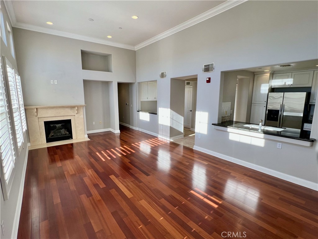 Unique top floor 2 bedroom 2 bath condo with 20 foot ceilings in the beautiful gated Carabella building available now for lease. Condo living with no shared walls. High ceilings with tons of natural light. Beautiful large courtyard facing patio. Open living space with modern kitchen & den/office. Resort style primary suite with trayed ceilings and ceiling fan. Primary spa like bath with dual sinks, separate shower, soaking bathtub, and large walk in closet. In unit washer/dryer, Nest thermostat, built in desk with plenty of storage. Includes refrigerator and stainless steel appliances. 2 parking spaces included (tandum) with dedicated Tesla charger. Rent includes high speed internet, water, trash, access to incredible fitness center which includes pool and jacuzzi. Walking distance to Whole Foods, Starbucks, Concert Park and other shops. Small pets ok.