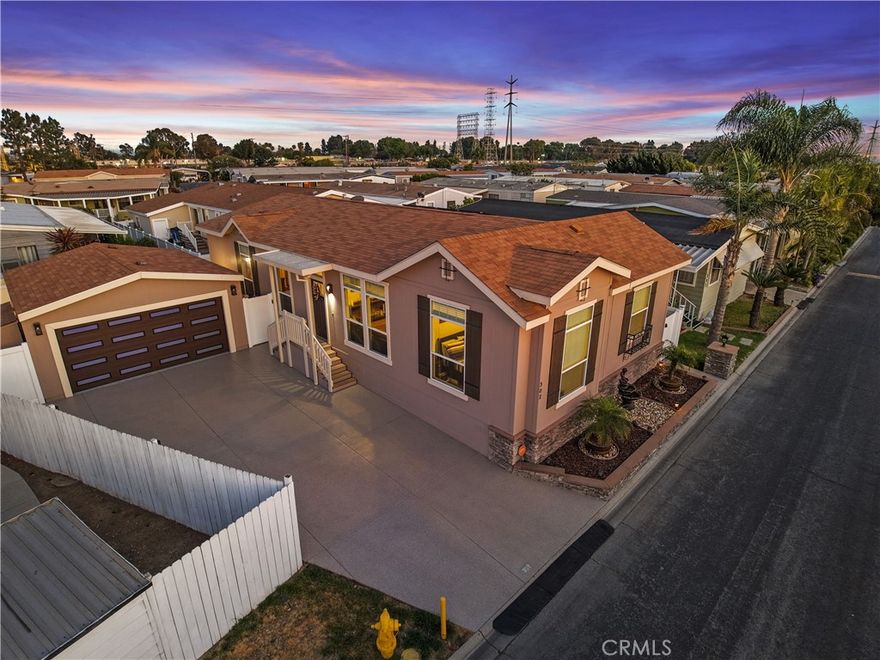 Turnkey 3-Bed, 2-Bath Home with Finished Garage & Owned Solar in Gated Community! Breathtakingly gorgeous luxury home with immaculate 2-car finished garage, owned solar system for energy efficiency (includes transferable warranty), and beautiful backyard oasis in all nestled prime location in coveted gated community. Built in 2017, this beautifully upgraded single-level home offers 3 bedrooms, 2 bathrooms, and luxury living in a secure, resort-style gated community. Featuring 10-ft ceilings, crown molding, recessed lighting, and coved ceilings, the open floor plan feels bright, airy, and upscale. Designer paint, stylish flooring, and ceiling fans add to the home's elegance and comfort. The spacious great room is filled with natural light and flows seamlessly into the dining area and chef’s kitchen, which features custom cabinetry, gleaming countertops, a center island with outlet, and a modern glass display cabinet. Stainless steel appliances are included: refrigerator, dishwasher, microwave, stove, oven, and a deep farmhouse sink with upgraded faucet. A striking chandelier elevates the dining experience. The private primary suite offers a peaceful retreat, complete with a bonus sitting area—ideal for an office, vanity, or lounge. The en suite bathroom includes a soaking tub, walk-in shower, and dual vanities with ample counter space. Two additional bedrooms are generously sized and share a well-appointed full bathroom with dual sinks and shower/tub combo. A dedicated laundry room provides extra storage and side-by-side washer/dryer hookups. This energy-efficient home includes an owned solar system, producing enough power for both the house and the garage. Car lovers and hobbyists will appreciate the immaculate finished 2-car garage with epoxy floors, insulated auto door, and finished walls—perfect for a gym, workshop, or flex space. The backyard is designed for both relaxation and entertaining, with a gated play area, expansive patio, and oversized custom driveway with durable coating. Crisp white vinyl fencing adds privacy, and low-maintenance landscaping ensures easy upkeep. Located in the heart of a 24/7 guard-gated community, residents enjoy top-tier amenities: resort-style pool and spa, playground, fitness center, sports court, and more. Perfectly maintained and ideal for all lifestyles, this home blends modern style, comfort, and efficiency in a prime location. Don’t miss your chance—schedule your private showing today!