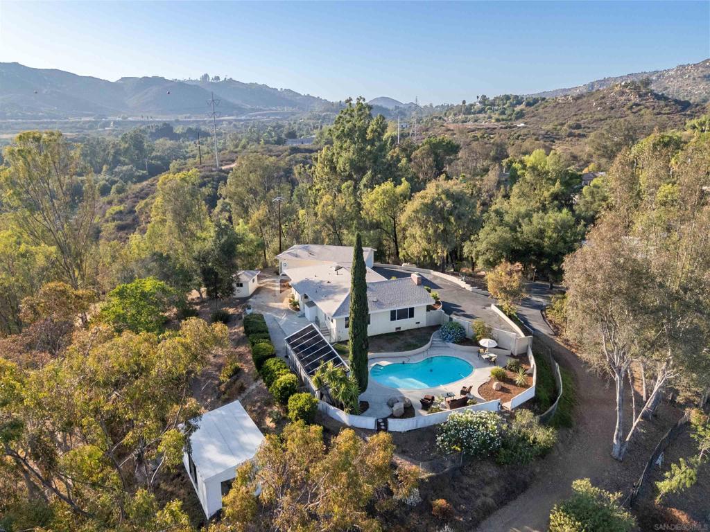 Nearly 3 acres of privacy in North Escondido with a spacious single-level home plus a detached studio featuring its own kitchenette, full bath, and large closet—ideal for multi-gen living, guests, or rental potential. Recent upgrades include a new roof, HVAC, electrical panels, septic system, flooring, paint & more. The kitchen features refreshed appliances, while open living spaces extend outdoors to a solar-heated pool and sweeping views. With plentiful parking, RV space, and easy I-15 access, this property delivers rare flexibility and value in today’s market. Nearly 3 acres of privacy in North Escondido set the stage for this thoughtfully updated single-story residence. The main home offers 4 bedrooms and 2 baths, while a detached studio with its own kitchenette, full bath, and large closet provides the flexibility today’s buyers crave—perfect for extended family, a guest retreat, or income potential. Extensive improvements completed between 2024–2025 deliver peace of mind for years to come: a brand-new roof and HVAC system, upgraded electrical with three new panels, rebuilt septic tank, repaved driveway, fresh interior paint and texture, updated flooring, and refreshed kitchen appliances. Outdoors, wide-open views and a solar-heated pool create the ideal setting for entertaining or quiet evenings at home. With plentiful parking, RV and toy storage, and multiple driveways, the property balances practicality with lifestyle. Conveniently located near I-15, schools, and shopping, this estate offers the best of North County living—modern upgrades, versatile spaces, and room to truly enjoy the San Diego lifestyle.