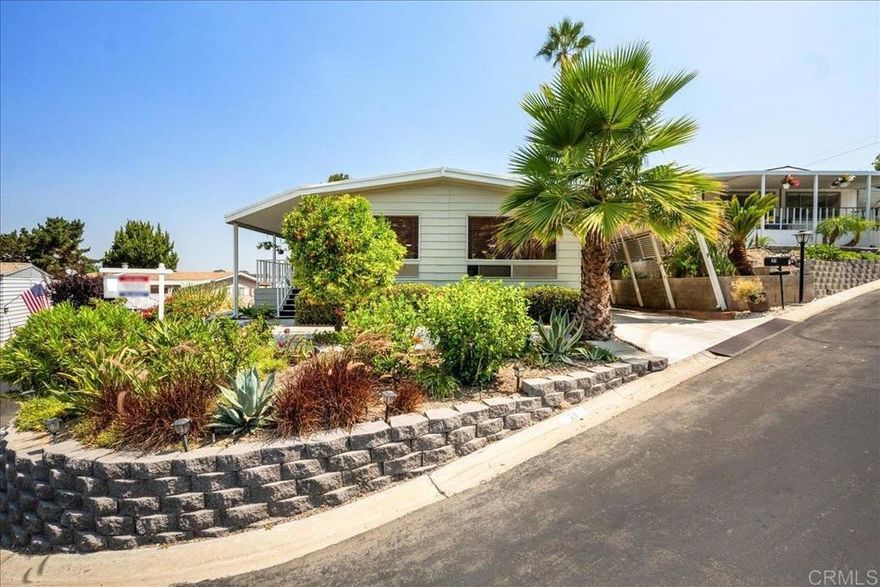 PRICE IMPROVEMENT. Distant Ocean View and Dramatic Sunsets! This home sits on one of the highest lots in the park, so you enjoy refreshing breezes. Beautiful updates to the kitchen and main bath. The California Room provides additional space for an office, crafts, or storage. New furnace, A/C, water heater, range, and roof. Large backyard with many fruit trees and two large storage sheds. You have added safety with earthquake bracing. Welcome to Green Valley MHP, a quiet 55+ community. Indulge in the amenities of this vibrant 55+ community, including a pool and spa to keep you refreshed on a warm day. The clubhouse offers a variety of entertainment options, including pool tables, darts, a library, a TV area, a fireplace, and a game table. The park is conveniently located near transportation, medical facilities, shopping, and is just a short drive from the beach. The park also has a low-cost RV parking area and a free car wash area. The space rent includes water, trash, and sewer. Two pets allowed.