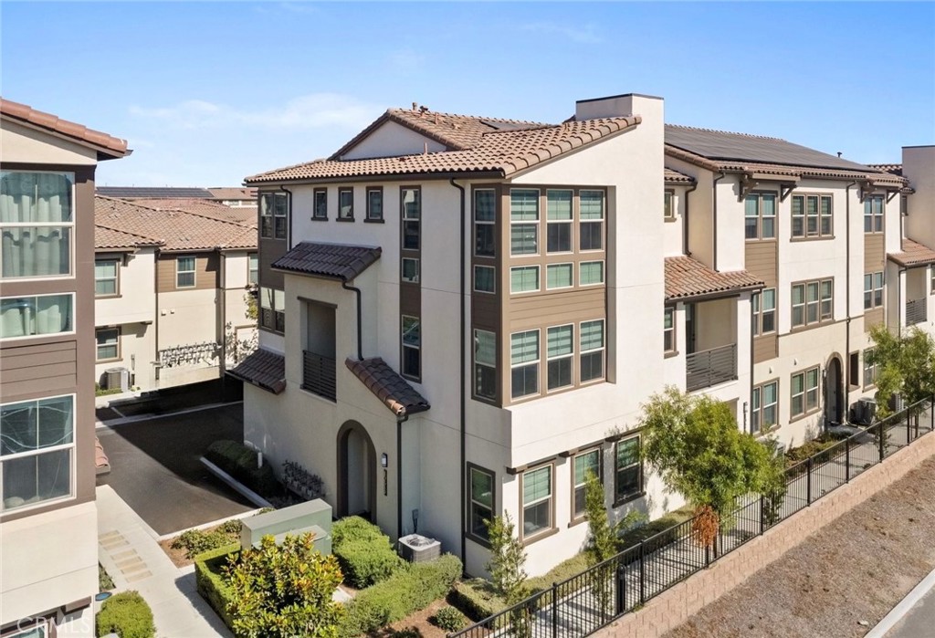 Built in 2022 with nearly $50,000 in builder upgrades, this beautiful end unit home offers fully paid solar and modern living at its finest.
Step inside to find a ground-level secondary primary suite with an ensuite bath featuring a walk-in shower. The entry level also includes an attached two-car garage.
Upstairs, the open-concept second level is perfect for entertaining. The gourmet kitchen boasts an oversized almost 9 ft island with polished European quartz counters, an upgraded backsplash, farmhouse sink, all soft-close cabinets and drawers, a recycling/trash drawer, and premium Samsung appliances—including an upgraded slide-in range. The space flows into a spacious dining area and living room, with access to a private balcony.
The third level features the main primary suite and two secondary bedrooms, plus a conveniently located laundry room with front-loading washer and dryer. The main primary suite offers sunset views, a walk-in closet, dual vanity with quartz counters, and a walk-in shower. All secondary bathrooms and the laundry room are finished with Bella Carrera marble counters.
Additional upgrades include custom window coverings, LED recessed lighting throughout, upgraded laminate flooring, an energy-efficient tankless water heater, fully paid solar, energy-efficient HVAC, a whole-house fan, and a programmable Honeywell Lyric Wi-Fi smart thermostat.
Residents enjoy community amenities including a pool, spa, BBQs, and picnic area. This home is conveniently located near Costco, Board & Brew, and is part of the Anaheim Union School District, with students attending highly regarded Cypress High School.