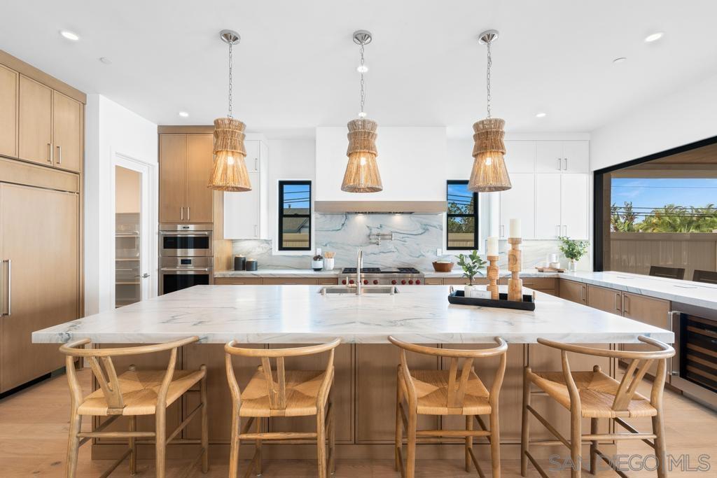 LAST HOME at HIGHLAND 5! This extraordinary Contemporary Coastal home is in a prime location within the exclusive Highland 5 enclave of Olde Carlsbad. This is one of 5 brand new construction homes, thoughtfully designed and built by a local family owned builders CalWest. Upon entering the 2910 Highland Drive you are immediately struck by the opulence of this property from the glistening pool with its fountains and spa, to the beautifully landscaped yard which features a covered loggia with fireplace and a fabulous one bedroomed, self-contained guest house. The home is designed with sophistication and comfort in mind. The floor plan has a natural flow, hardwood flooring which adds a timeless elegance, and it is bathed in abundant light from the oversized sliders to the black framed windows throughout. Designed with family and entertaining in mind the stunning kitchen is at the center of the home. The chef’s kitchen is filled with high-end materials, custom cabinetry, a huge island, Wolf and SubZero appliances. The great room features dining and living rooms with a dramatic fireplace wall. A secondary en suite bedroom/office, powder room and laundry room complete the first floor. Upstairs boasts ocean views, an expansive primary en suite bedroom with large balcony, two secondary bedrooms, 2 full bathrooms, and a large family room. There is plenty of storage throughout the house, and an attached 3-car garage. This home truly has it all and is an opportunity not to be missed.