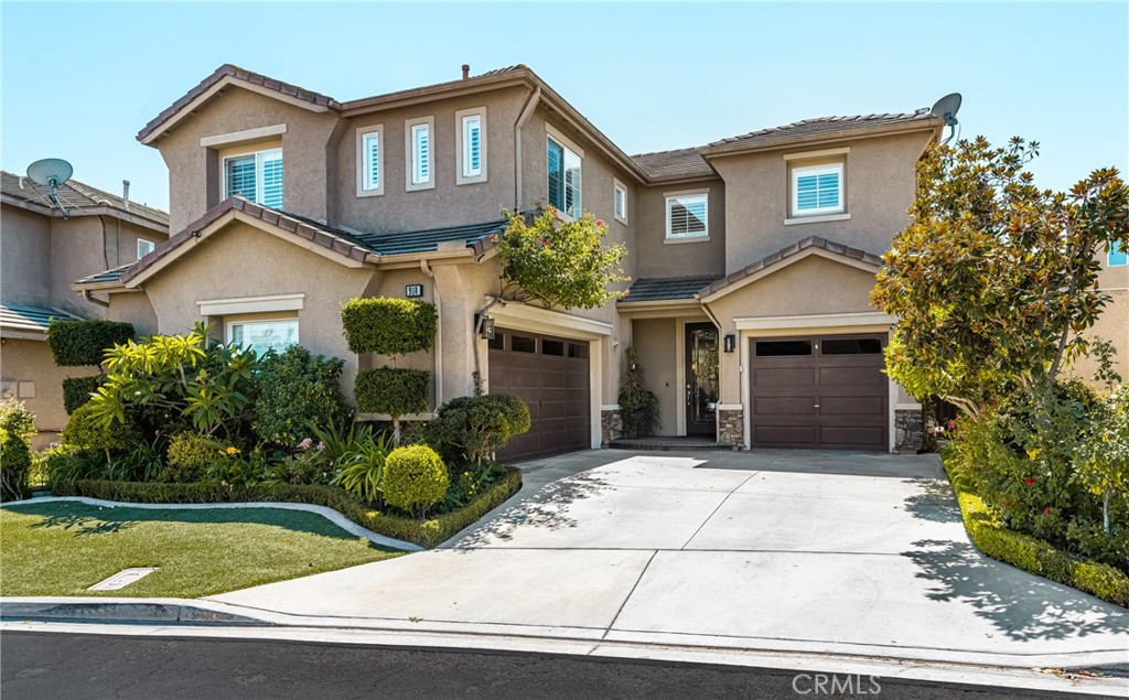 This beautifully upgraded home offers everything you’ve been searching for—style, comfort, and resort-like amenities. Featuring 3 bedrooms plus a loft, built in 1999, this 2,300 sq. ft. residence includes a 3-car attached garage and sits in the highly desirable Alta Vista community. From the moment you step through the lovely beveled glass front door, you’ll be greeted by an open and inviting floor plan. The remodeled kitchen shines with quartz countertops, white shaker cabinetry with pull-out shelves, spice rack, self-closing drawers, pantry with a 30-bottle wine rack, stainless steel appliances and a designer tile backsplash. Luxury vinyl plank and tile flooring, paired with upgraded baseboards, flow seamlessly throughout the home. The family room is a true gathering space, showcasing a cozy brick fireplace with a custom mantle and slider that opens to your backyard oasis. Upstairs, the primary suite features vaulted ceilings, a ceiling fan, custom walk-in closet, and a spa-like bathroom with a soaking tub, quartz dual sinks and a step-in shower with multiple shower heads. A convenient upstairs laundry room adds everyday ease. Enjoy resort-style relaxation with your private saltwater pool and spa, complemented by low-maintenance landscaping, artificial turf and a drip irrigation system for energy efficiency. Additional highlights include surround sound, designer light fixtures, custom closet organizers, recessed lighting, wrought iron custom staircase, custom built-ins, crown molding, upgraded windows and slider, plantation shutters, whole-house fan, water softener, multi security cameras, tankless water heater and a solar system for long-term savings. This home is ideally located within walking distance of Alta Vista Country Club & Golf Course, Champions Sports Park, shopping, and dining. Award winning Placentia/YL school district. Low HOA dues also include access to a community pool and spa. Your home search ends here—this Alta Vista gem truly has it all!