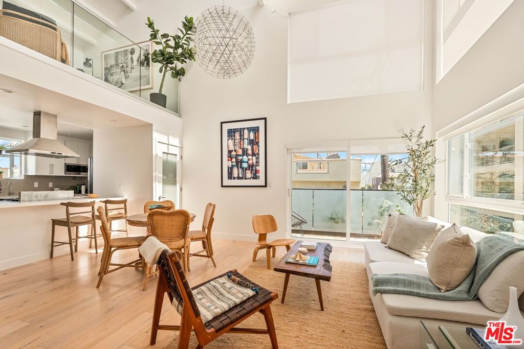 Fully Renovated, 2 Bed + 2 Bath + Loft + Roof deck + Side by Side Garage - Multi-Level beach condo, perfectly positioned on the coveted Marina del Rey Peninsula! Light & airy, south-facing with large windows highlighting the modern architecture - Dramatic 2-story ceilings accentuate the living room with rich wood detailing & glass railings, gorgeous wide plank hardwood floors elevate the modern aesthetic. The chef's kitchen is a showstopper, boasting custom cabinetry, luxurious stone countertops, stainless steel appliances, and a convenient eat-in bar-perfect for casual meals or entertaining guests. With two generously sized bedrooms and two stylishly updated bathrooms, there's plenty of space to relax and recharge. Ample closet space adds practical appeal. Upstairs, a versatile loft space makes an ideal home office or creative studio, leading to a private rooftop deck where you can soak up the sun or enjoy peaceful evenings under the stars. The home also includes a rare two-car side-by-side garage with electric vehicle charger for added convenience. Located just steps from the sand on the Marina del Rey Peninsula - moments from all the best this amazing area has to offer -- trendy cafes, acclaimed restaurants, Abbot Kinney, Venice Canals, main channel, Fisherman's Wharf, and exquisite shopping and entertainment. This is coastal living at its finest. You can watch the sunset on the beach every night just steps away!