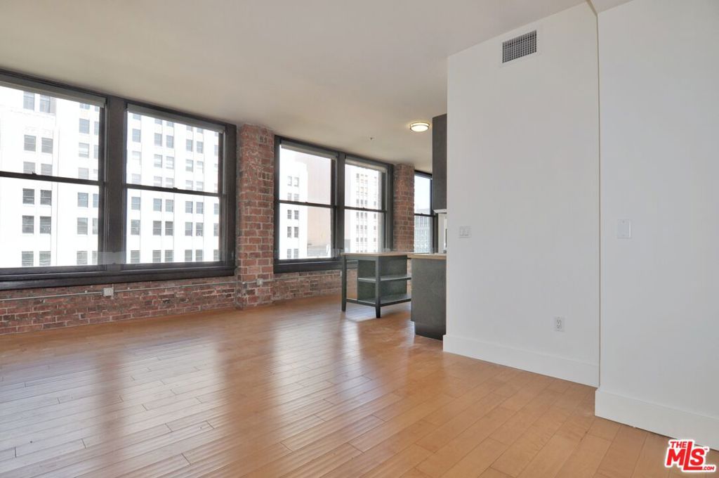 Charming LIVE/WORK corner loft with spectacular views of the west-side skyline, sunsets and the Spring Street Park. This 1 bed, 1 bath, 7th floor loft in the historic Rowan Building features 2 entire walls of exposed brick and massive windows that bring in tons of natural light. The loft features wood floors throughout and 10ft tall ceilings, and an open living/kitchen/dining layout ideal for entertaining. The kitchen features Italian Scavolini cabinetry, stainless steel appliances that include, dishwasher, oven, fridge, and microwave, and granite countertops. The bedroom is nicely separated, gets amazing natural light and views from 2 massive windows, and features a wall-to-wall closet, WD inside another closet, and ensuite bath. Amenities include 24/7 front desk security and reception desk that can accept and hold deliveries, well-maintained outdoor deck with hot and cold plunge pools, resident lounge, BBQs, outdoor dining/lounge area, extra basement storage options. Within a few short blocks of Grand Central Market, Metro, Arts District, Little Tokyo, The Broad, Whole Foods, Grand Park, weekly Farmer's Market, tons of coffee shops & dining hot spots and more. Parking is not included in rent, but there is a paid monthly parking garage where many residents park with direct access via a walkway behind the building.