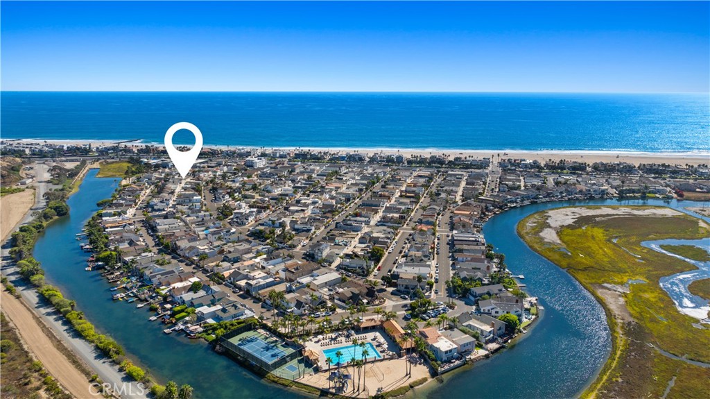 Look no further for quintessential Newport Beach living - welcome to 235 62nd Street. Nestled in the coveted coastal enclave of Newport Shores, this thoughtfully updated mid-century modern home offers the perfect blend of beachside charm, timeless design, and access to one of the most amenity-rich communities in the area. Step inside to soaring ceilings, warm hardwood floors, and an abundance of natural light flowing throughout the 1,650 square feet of curated living space. The heart of the home is the recently remodeled gourmet kitchen, reimagined with sleek quartz countertops, Viking appliances, custom cabinetry, built-in refrigerator, and designer lighting, all centered around a cozy built-in breakfast nook with views toward the private deck. Seamlessly blend indoor-outdoor living with sliders to the spacious deck, perfect for morning coffee, soaking up the sun, or dining alfresco. Adjacent to the spacious living area, a flexible bonus room offers endless possibilities: create a dedicated office, den, or easily convert it back into a fourth bedroom. Two generous-sized bedrooms, both with vaulted ceilings and large windows, and two stylish bathrooms round out the first floor living space. The attached two-car garage includes interior access and convenient laundry. Upstairs, the private primary suite serves as a true retreat with vaulted ceilings, abundant closet space, and a luxurious ensuite bathroom complete with soaking tub and elevated finishes. A separate, private room off the primary offers the perfect flex space, ideal for a nursery, home gym, reading room, or creative studio, opening to a balcony with ocean breezes and tranquil views. Located just a short stroll from the sand, 235 62nd Street also offers access to the exclusive Newport Shores amenities, including a clubhouse, resort-style pool, tennis and sand volleyball courts, basketball, and year-round community events. Enjoy proximity to iconic beaches, top-rated restaurants, local parks, and everything that makes Newport Shores one of the most desirable pockets of Southern California. Timeless design, indoor-outdoor ease, and a true sense of community - this is beachside living, redefined.