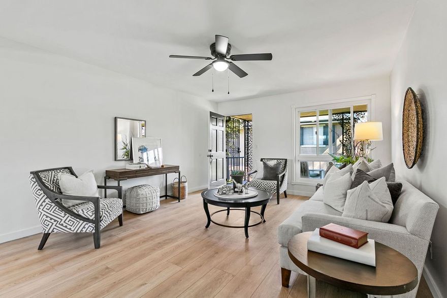 Live where charm, character, and convenience meet—right in the heart of Old Towne Orange. Tucked inside the New Orleans–inspired enclave of Park Orleans, this upper-level corner condo delivers privacy and personality. Just behind your home, a smart-opener garage offers easy access and modern practicality. Step inside and be surprised by how spacious a two-bedroom condo can feel. Updated flooring and fresh paint flow through an airy living area—perfect for cozy nights in, morning coffee by the picture window, or dinner parties that spill onto your private deck framed by lush green space and classic wrought-iron details. The refreshed kitchen features painted cabinetry (with pantry), subway-tile backsplash, new stainless-steel appliances, new hardware and faucet, plus a convenient ceiling light & fan. Built-ins in the hallway and an updated bathroom with a stone tile & glass enclosure shower/tub combo offer both function and style. Two serene bedrooms feature ceiling fans, chair rail, and soft window coverings in the larger room, making the home feel warm and truly livable. Smart updates include a new Wi-Fi-enabled wall A/C and heat unit, replaced panes in the Milgard windows, newer flooring, and fresh paint throughout. Park Orleans residents enjoy a sparkling pool, manicured grounds, and HOA-covered water, trash, sewer, and landscaping—plus the option to apply for a second parking spot permit. From here, stroll to Hart Park’s concerts and trails, the fun shops and cafés of the Plaza, or your favorite craft brewery around the corner. Whether you’re starting out, scaling down, or simply seeking low-maintenance living with timeless Old Towne character, 660 S Glassell St #80 is ready to welcome you home.