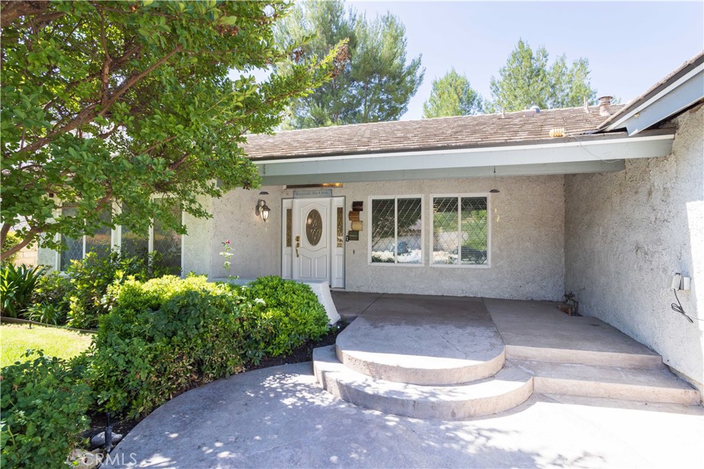 It’s time to trade stairs for memories—move into a single-story home where comfort meets family living. This home is nestled amidst gently rolling hills in the prestigious neighborhood of Vista Ridge, Valencia. As soon as you lay your eyes on it you'll immediately recognize the owner's true "Pride-Of-Ownership." Here are a few of the main house's fine features: Lush landscaping, manicured planters, mature shade trees, and custom hardscape enhance its eye-catching curb appeal *You'll step into a flowing 1,938 square foot open concept floor plan that is in "Pristine Condition" with vaulted ceilings, recessed lighting, and an aesthetic blend of wood, tile and plush carpet flooring * The spacious living room is bathed in natural light from large picture windows * The family's chef is going to truly appreciate the stunningly updated kitchen's abundant custom cabinets with counter lights, ample granite counters with full back-splash, large center island with built-in breakfast bar, gas cooktop with custom ventilation hood, built-in stainless steel appliances, and the convenience of the adjoining dining room * The family room has mantled fireplace and direct patio access * All 4 bedrooms have efficient ceiling fans; The grand suite also has direct backyard access, a large walk-in closet, and a sumptuously appointed custom tiled bathroom with dual sink mirrored vanity, soothing spa tub, and glass enclosed shower * A total of 2 bathrooms * Functionally located laundry * Energy efficient dual pane windows will help keep your utility bills low and the interior very quiet * Central air & heat * You're going to appreciate the backyard's privacy fencing, lush landscaping, and covered stamped concrete entertainer's patio * New ADU's features: *429 square foot studio floor plan with vaulted wood-beamed ceiling, recessed lighting and laminate flooring * Well appointed kitchen with abundant cabinets, quartz counters, durable stainless steel sink, and built-in stainless steel appliances, and breakfast bar * Stackable laundry area * 1 bathroom * ADU is perfect for potential rental income, college student, traveling nurses, or perhaps you have and elderly loved one you'd like to have close by to help and avoid the high costs and risks of an assisted care facility *Experience Enjoy the community's, sparkling pool, 2 spas, plus the tennis and pickleball courts * Great location close to award winning schools, shopping, fine dining, Vista Valencia Golf Course, and the 5 freeway