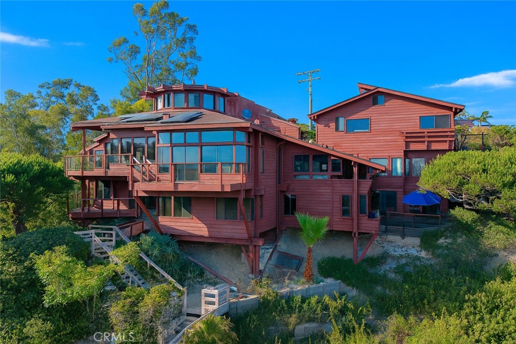 One-of-a-Kind Architectural 9-Level Masterpiece with Ocean Views
237 W Avenida Alessandro, San Clemente
Welcome to an extraordinary coastal estate in the heart of San Clemente’s sought-after Riviera District. Set on over 1.8 acres, this custom cedar and glass residence offers 7 bedrooms, 5 bathrooms, and approximately 8,254 square feet of refined living space. Designed by award-winning architect John McInnes, this home showcases exceptional craftsmanship and architectural distinction.
Featured in Orange County Homes & Gardens, this one-of-a-kind property captures sweeping ocean views, fresh sea breezes, and seamless indoor-outdoor living from multiple balconies. Designed for elevated entertaining and everyday comfort, the home features soaring ceilings, a chef’s kitchen, expansive living areas, a wet bar, and a private elevator. No HOA costs or restrictions. Property includes two separate APN numbers, offering flexibility, privacy and investment potential.
At the heart of the home is a dramatic indoor jacuzzi, a striking focal point adding spa-like serenity. The primary suite offers a large jetted tub, two-headed shower, and is thoughtfully located on the lower level beside a tranquil stream and waterfall, creating a private retreat.
A standout is the private observatory with wet bar and breathtaking ocean and surf views, perfect for sunset cocktails or stargazing.
Features include 31 solar panels, four 220V outlets, a fire-retardant composite roof, and a quiet location near top schools. Large frontage allows multi-car parking.
Adding rare value is a built-in income opportunity, with multiple rentable units integrated into the structure. Ideal for multigenerational living, guests, or rental income. This luxury home is among the lowest price-per-square-foot opportunities in all coastal communities west of I-5.
Surrounded by mature landscaping and just a 10-minute walk to the beach, this estate blends space, artistry, and lifestyle. Whether relaxing in the jacuzzi, watching waves from the observatory, or hosting gatherings, 237 W Avenida Alessandro is a once-in-a-lifetime chance to own a coastal masterpiece with both luxury and income potential.
Just a short stroll to world-class surf, Riviera Beach, and San Clemente’s vibrant downtown, this estate offers a rare blend of artistry, energy efficiency, and income potential. A true legacy property—crafted for those who value space, freedom, and the unmatched coastal lifestyle.