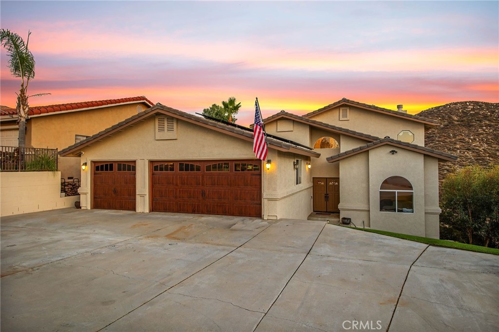 Welcome to this beautifully positioned 3-bedroom, 3-bath home offering sweeping panoramic views and a sense of privacy rarely found in Canyon Lake. With 2,060 sqft of thoughtfully designed living space and a 3-car garage, this home combines comfort, functionality, and unmatched potential. Step inside to an open floor plan that draws you in with stunning views from the main living areas. The upgraded kitchen features high-gloss lacquer cabinets, modern appliances, and a seamless flow ideal for both daily living and entertaining. Wood and tile flooring add warmth and durability throughout the main spaces, while each of the generously sized bedrooms offers upgraded carpet and fresh paint. The spacious primary suite includes a private balcony overlooking the hills—perfect for enjoying your morning coffee or winding down in the evening. All bathrooms have been tastefully updated with tile flooring and contemporary finishes. Outside, the tropical-inspired front yard sets the tone for relaxed lake living, and the expansive backyard offers a blank canvas for your dream outdoor retreat. Additional highlights include newer custom garage doors and openers, plus energy-efficient solar to help keep utility costs low. If all of that wasn't enough, Canyon Lake is a private, gated community with all gates staffed with security 24/7. Amazing amenities including a 384 acre waterski/fishing lake, 20 parks most with beaches and playsets, basketball courts, baseball fields, tennis & pickle ball courts, equestrian center, 18-hole golf course, pools, dog park, golf cart friendly streets, slalom course, ski jump, restaurants, community events and so much more!!