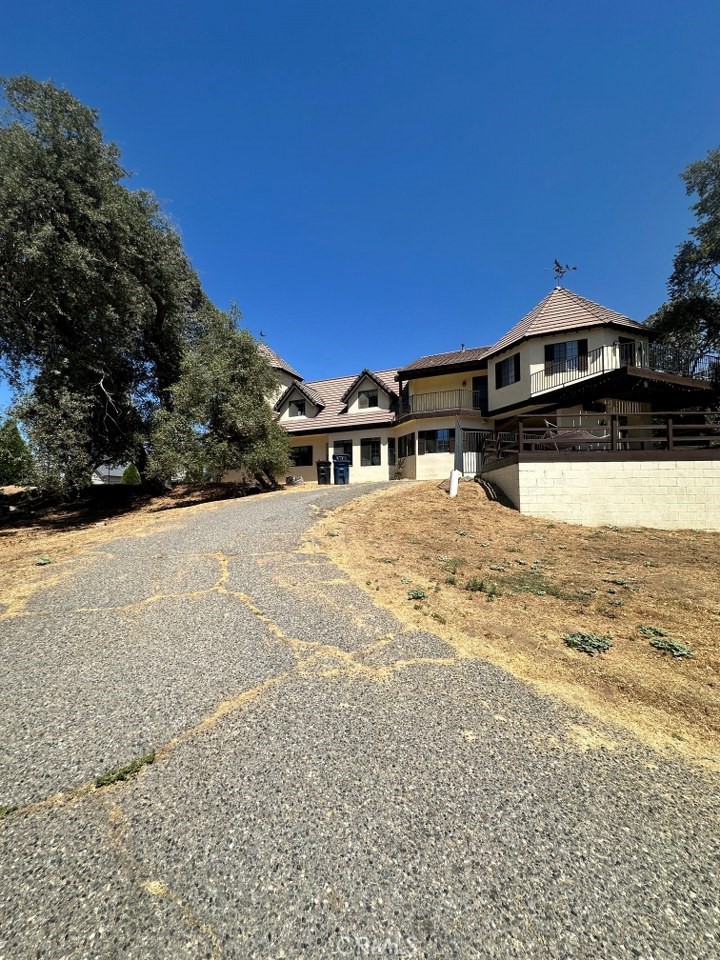 This stunning 5 bedroom, 3.5 bathroom craftsman home offering exceptional renovation potential in one of Oakhurst's most desirable neighborhoods. Spanning 4,351+/- sq. ft., this custom-built residence showcases beautiful beamed ceilings & spacious bedrooms throughout, creating an ideal canvas for your vision. The property sits on a generous, usable lot featuring multiple outdoor entertainment spaces. Expansive decks provide perfect vantage points to enjoy the surrounding views, while a built-in fenced pool offers year-round recreation. The thoughtfully designed courtyard creates an intimate setting for family gatherings & entertaining friends. A dedicated garden area adds to the property's charm & functionality. Energy efficiency comes standard with leased solar panels, keeping monthly utility costs manageable. This eco-friendly feature demonstrates the home's forward-thinking design while providing substantial savings for the new owners. Location advantages abound in this prime Oakhurst setting. Residents enjoy easy access to world-class recreation with Yosemite National Park just 30 minutes away and Bass Lake a convenient 15 minute drive. The neighborhood benefits from proximity to quality educational facilities, including John Muir Academy, & outdoor recreation opportunities at Fresno River Recreation Area. The craftsman architecture provides a solid foundation with distinctive character details that honor the home's original design while offering endless possibilities for modern updates. Large bedrooms throughout ensure comfortable living for families of all sizes, while the 3.5 bathrooms provide practical convenience. This property represents an outstanding opportunity to create your dream home in a location that perfectly balances small town charm with access to California's most treasured natural attractions. The combination of substantial square footage, unique architectural features, desirable neighborhood amenities & proximity to both educational facilities & recreational destinations makes this home a rare find in today's market.