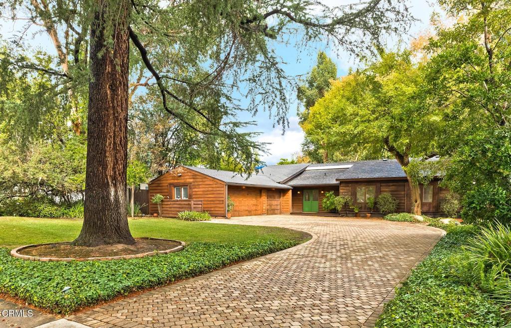 Welcome to a truly special ranch style home in one of Pasadena's most desirable neighborhoods -- a place where timeless charm meets modern comfort .Set on a generous, beautifully landscaped lot with mature trees, well maintained gardens, and a private driveway, this inviting property includes a three car garage and a versatile workshop -- perfect for hobbies, storage, or creative space.Inside, you'll find a light-filled, thoughtfully designed interior with an open floor plan, high ceilings, and great flow for everyday living and entertaining. The spacious living room with its stone fireplace feels warm and welcoming, while the formal dining area and large kitchen (with extra casual dining space) are ideal for gatherings with friends and family.The home offers three bedrooms, three beautifully updated bathrooms, hardwood and stone tile flooring, and plenty of well-designed storage throughout.Step outside to a peaceful garden patio -- a perfect spot for morning coffee or evening entertaining.This home is full of heart and style, tucked away in a serene setting yet just minutes from Pasadena's best shops, dining, and everyday conveniences.