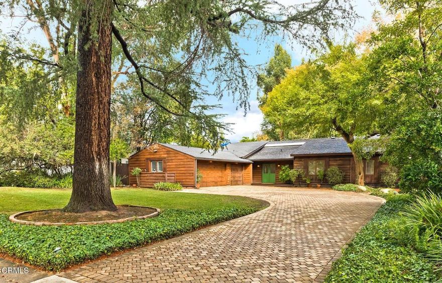 Welcome to a truly special ranch style home in one of Pasadena's most desirable neighborhoods -- a place where timeless charm meets modern comfort .Set on a generous, beautifully landscaped lot with mature trees, well maintained gardens, and a private driveway, this inviting property includes a three car garage and a versatile workshop -- perfect for hobbies, storage, or creative space.Inside, you'll find a light-filled, thoughtfully designed interior with an open floor plan, high ceilings, and great flow for everyday living and entertaining. The spacious living room with its stone fireplace feels warm and welcoming, while the formal dining area and large kitchen (with extra casual dining space) are ideal for gatherings with friends and family.The home offers three bedrooms, three beautifully updated bathrooms, hardwood and stone tile flooring, and plenty of well-designed storage throughout.Step outside to a peaceful garden patio -- a perfect spot for morning coffee or evening entertaining.This home is full of heart and style, tucked away in a serene setting yet just minutes from Pasadena's best shops, dining, and everyday conveniences.