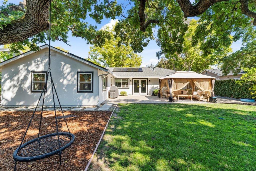 At last, the modern ranch you've been waiting for! Thoughtfully expanded and completely remodeled in 2019 with over $270K in upgrades, this home was designed to impress. Luxury vinyl plank flooring, custom finishes, and sleek hardware create a warm, contemporary flow that seamlessly connects indoor and outdoor living. The Pinterest-worthy kitchen is an entertainers dream, featuring all-new cabinetry, striking veined quartz counters, a farmhouse sink, floating shelves with designer tile, and stainless steel appliances. The private primary suite offers a spa-like retreat with a double floating vanity, timeless finishes, and a walk-in closet. More recently, an additional $50K in improvements enhance both lifestyle and peace of mind. Owned solar panels cut monthly energy costs, while a $5,000 high-efficiency wood fireplace insert fills the home with warmth on chilly days. Behind the scenes, the original water pipes and sewer lateral have been fully replaced, major investments that ensure reliability for years to come. Outdoors, a stamped concrete patio overlooks a spacious, low-maintenance backyard, perfect for summer evenings under the canopy of a majestic heritage oak.